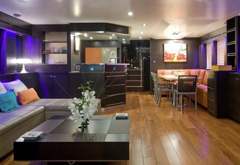 a living room with a large fireplace aboard AKISSI Yacht for Sale