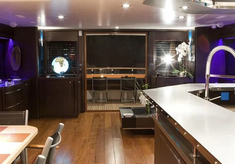 a large kitchen with a large screen aboard AKISSI Yacht for Sale