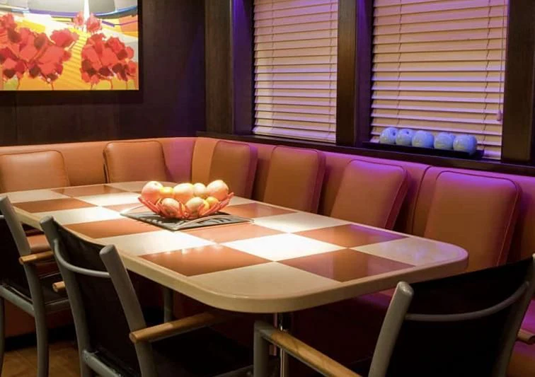 a table with plates and chairs aboard AKISSI Yacht for Sale