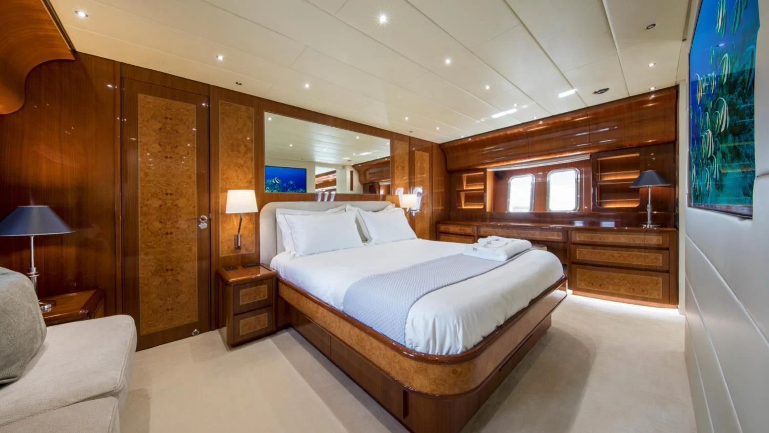 a room with a bed and a desk aboard CITA Yacht for Sale