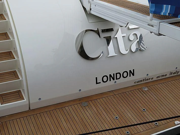 a white wall with a sign and a wood floor aboard CITA Yacht for Sale