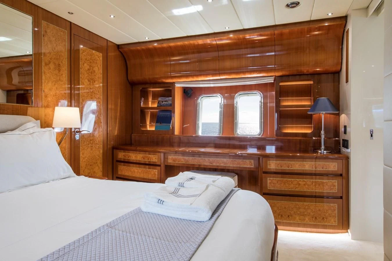a bed with a wooden headboard aboard CITA Yacht for Sale