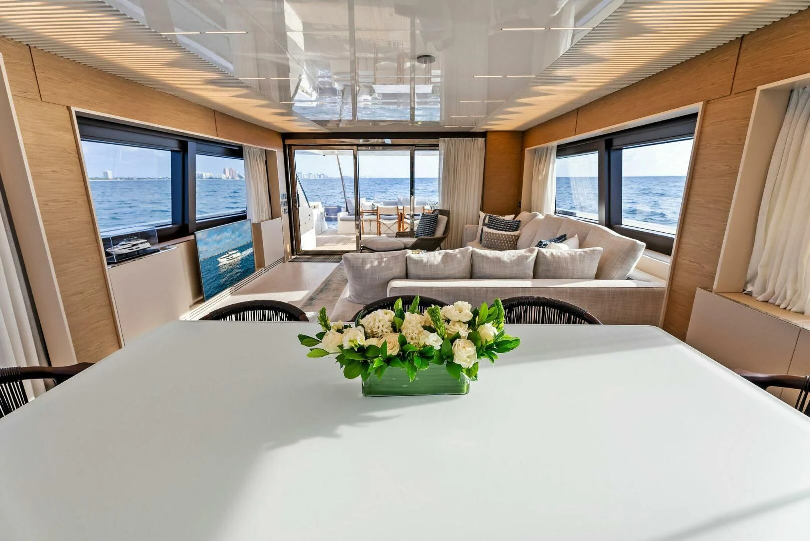 a large white table with flowers on it aboard SILHOUETTE Yacht for Sale