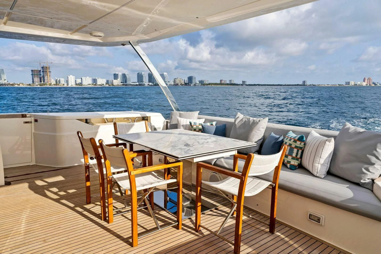 a table and chairs on a deck overlooking a large body of water aboard SILHOUETTE Yacht for Sale