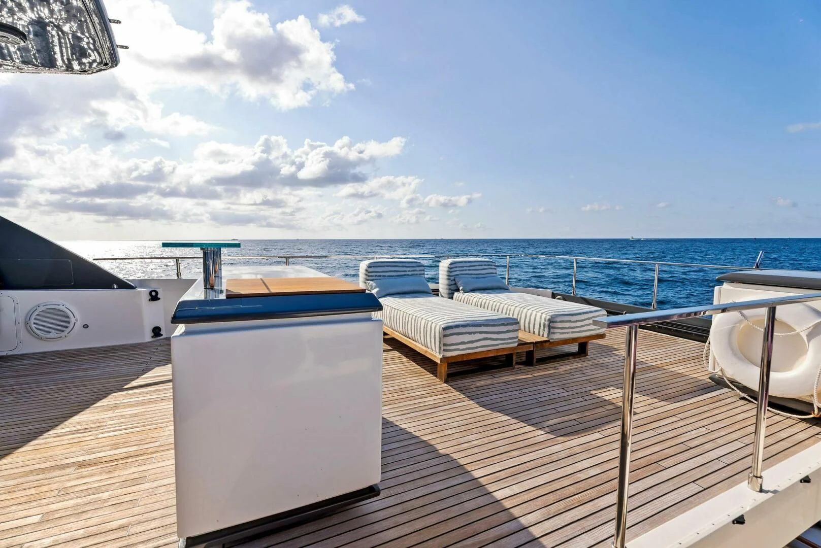 a deck with a view of the ocean and a boat on it aboard SILHOUETTE Yacht for Sale