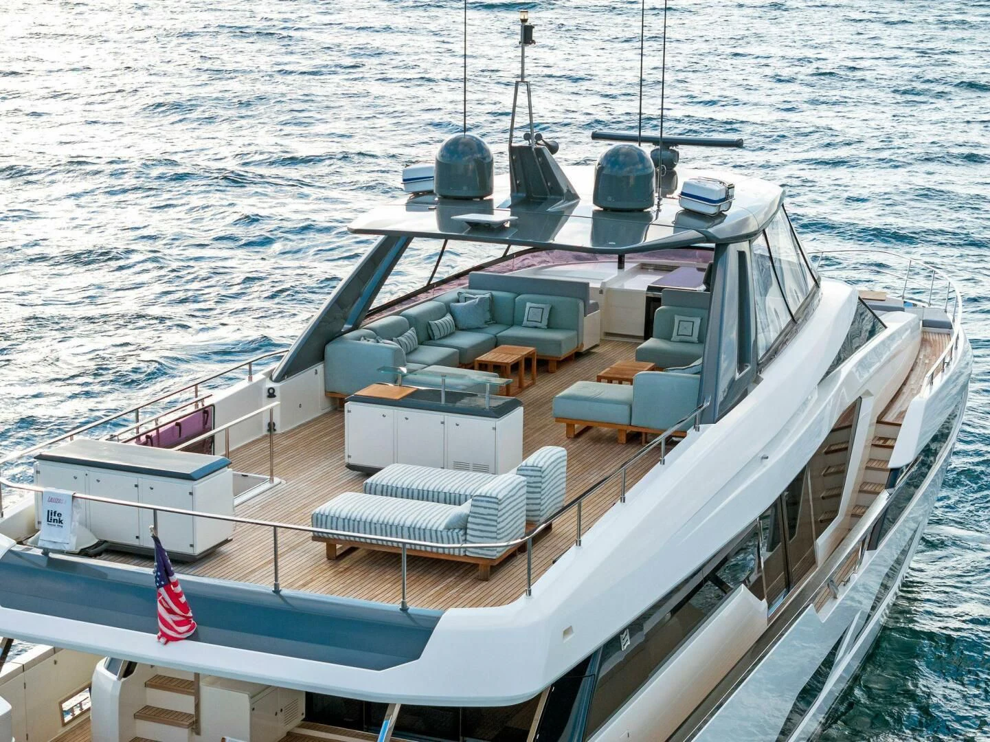 a large ship with a deck and a deck with a deck and a deck with chairs on it aboard SILHOUETTE Yacht for Sale
