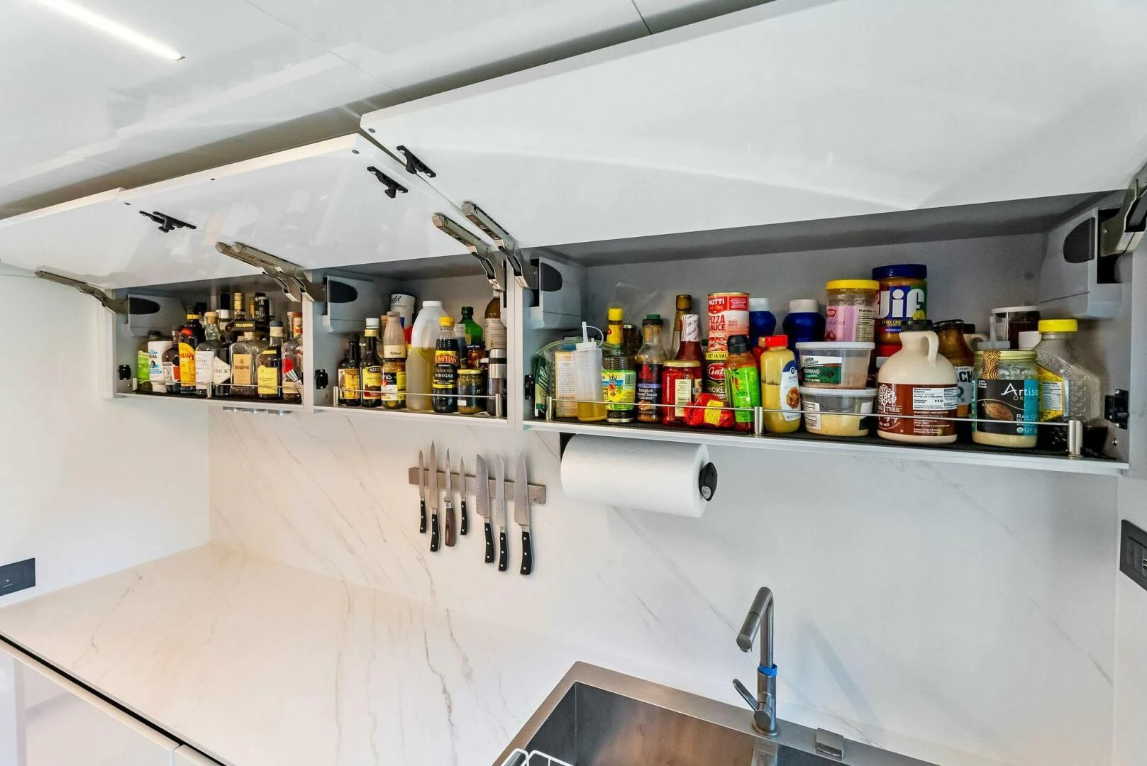 a kitchen with a lot of bottles on the shelves aboard SILHOUETTE Yacht for Sale