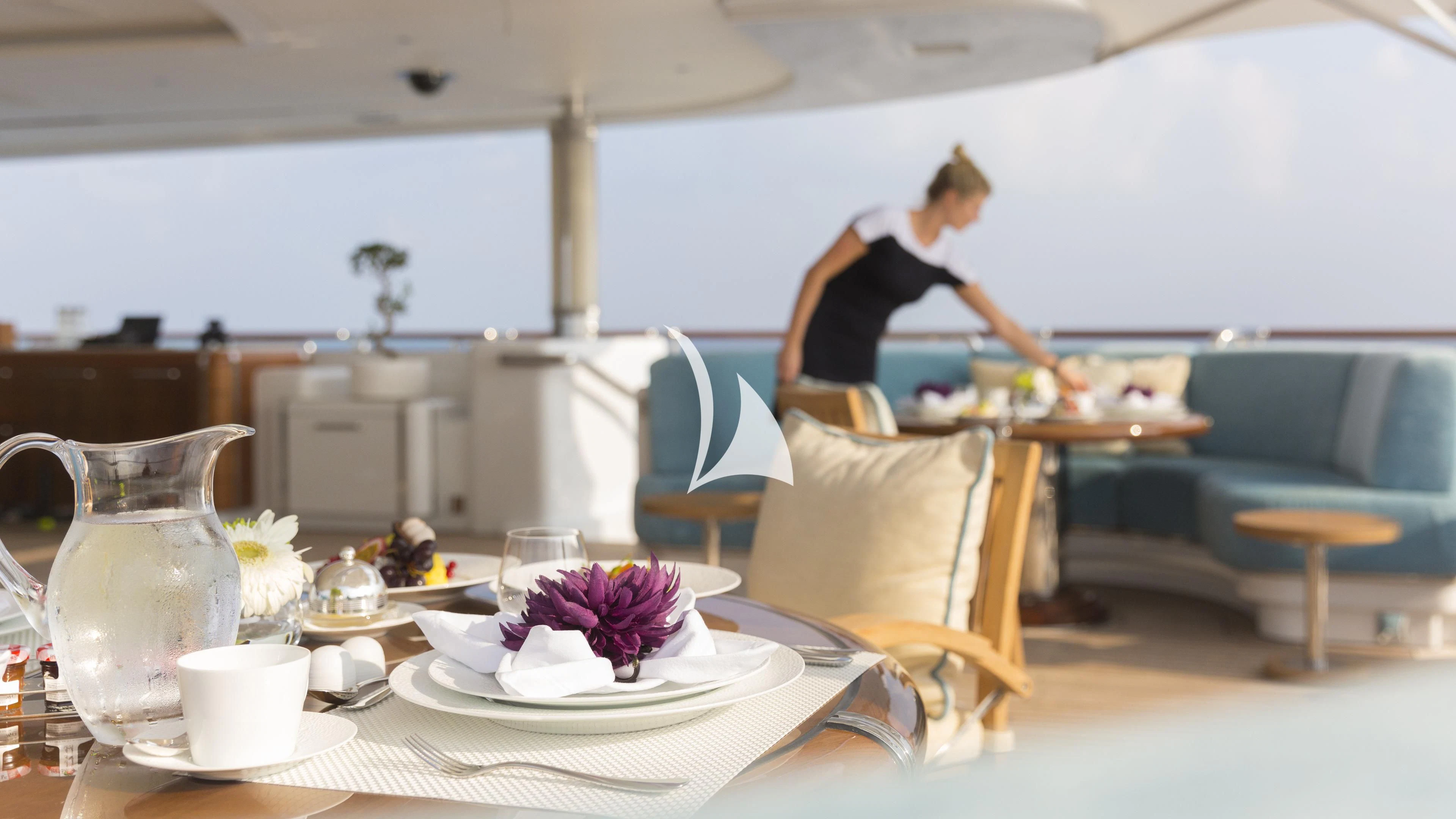 a person sitting at a table aboard NIRVANA Yacht for Sale