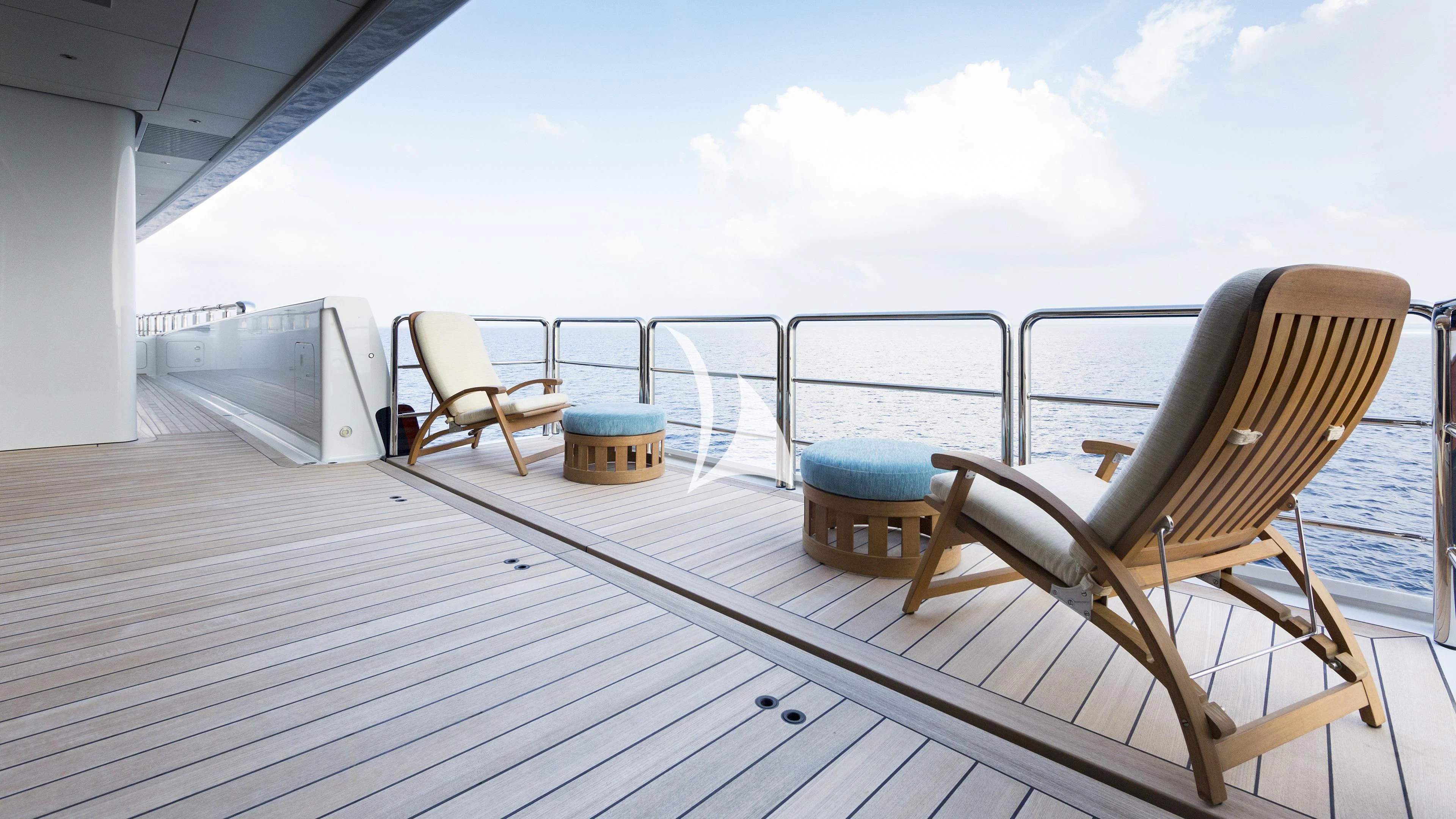 a deck with chairs and a table aboard NIRVANA Yacht for Sale