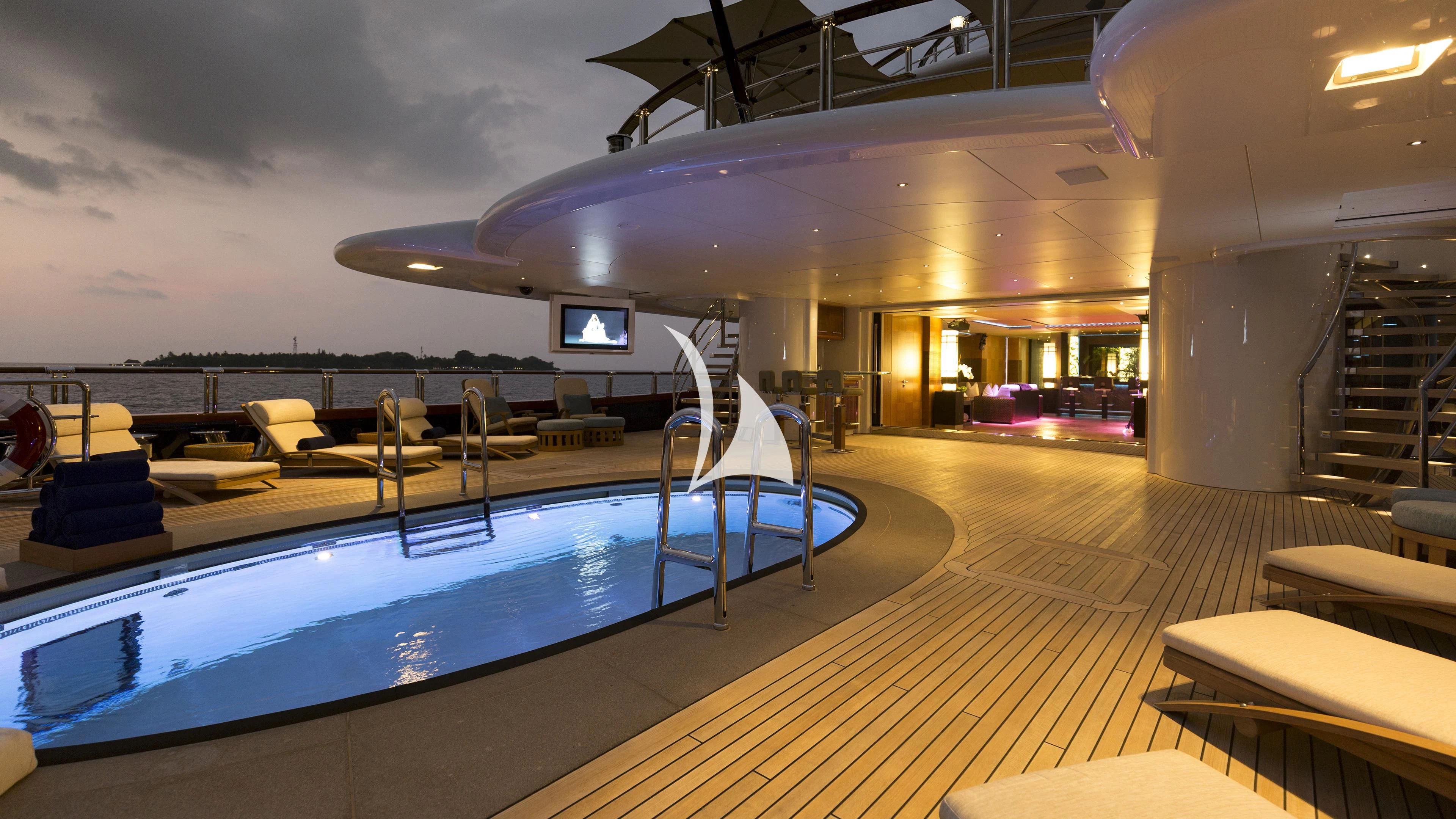 a room with a pool table and chairs aboard NIRVANA Yacht for Sale