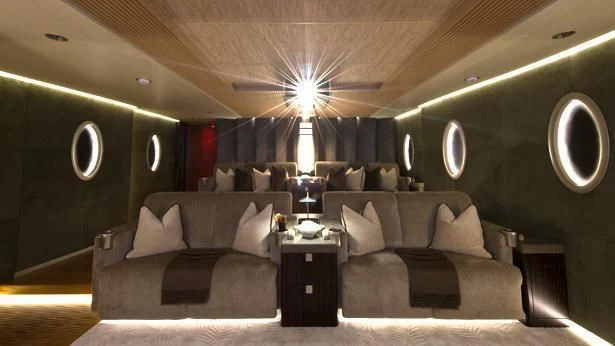 a large living room with a large couch and a large window aboard NIRVANA Yacht for Sale