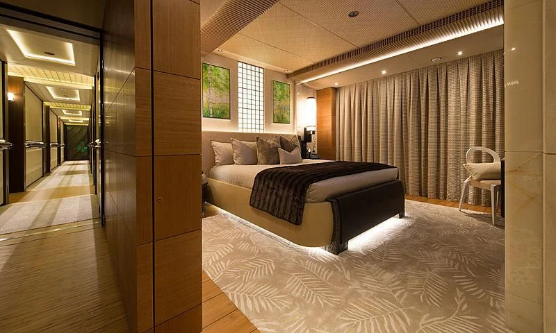 a bedroom with a bed and a desk aboard NIRVANA Yacht for Sale