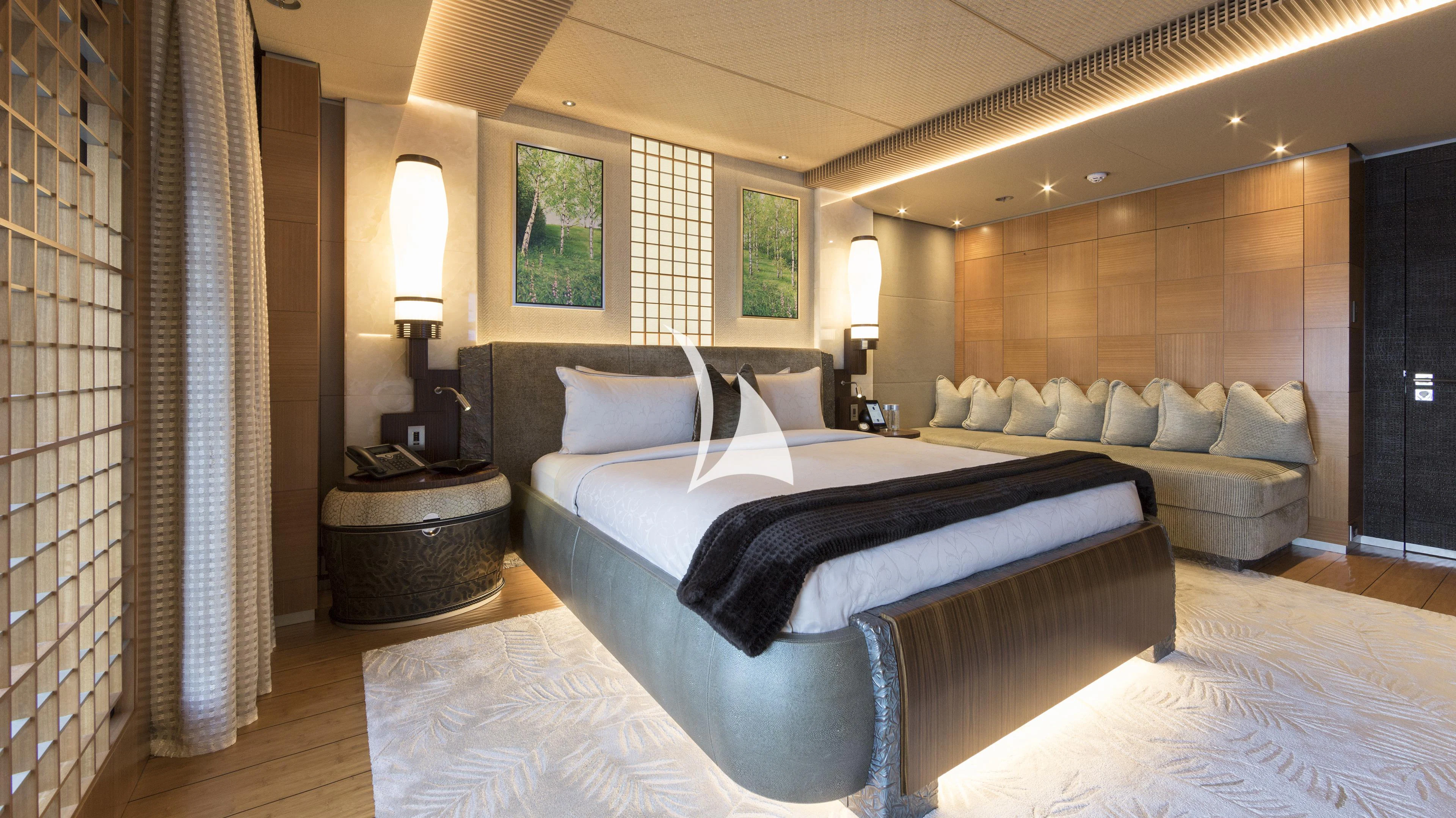a large bedroom with a bed and a couch aboard NIRVANA Yacht for Sale