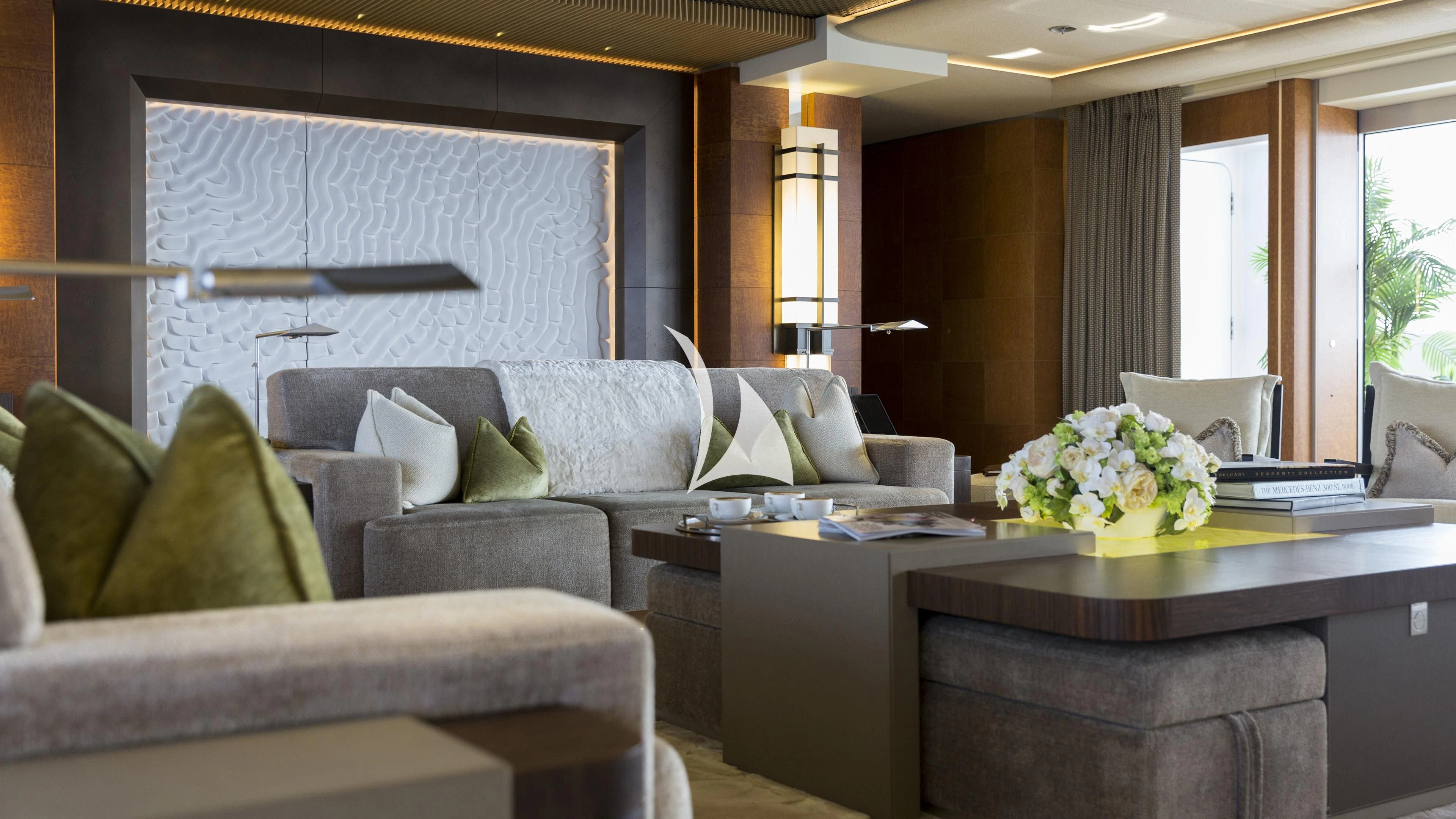 a living room with a couch and a coffee table aboard NIRVANA Yacht for Sale