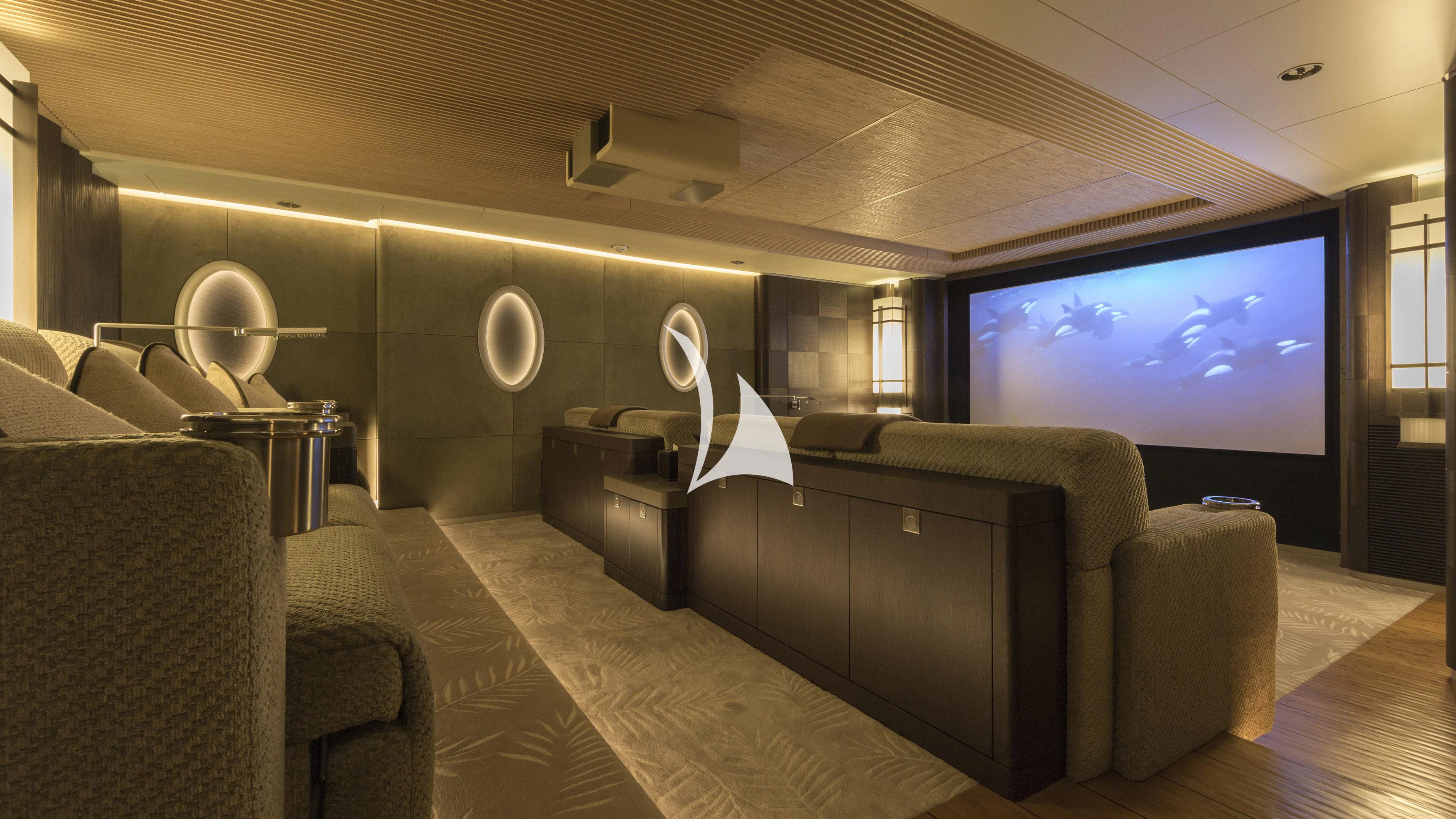 a large room with couches and a tv aboard NIRVANA Yacht for Sale