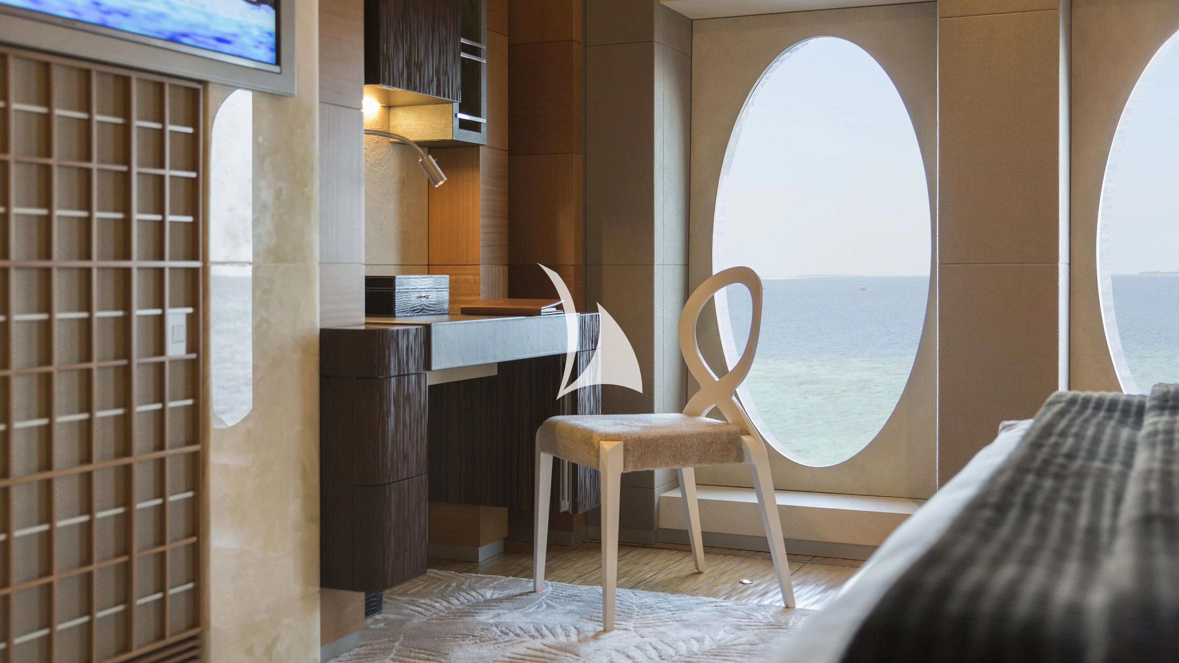 a chair next to a table aboard NIRVANA Yacht for Sale