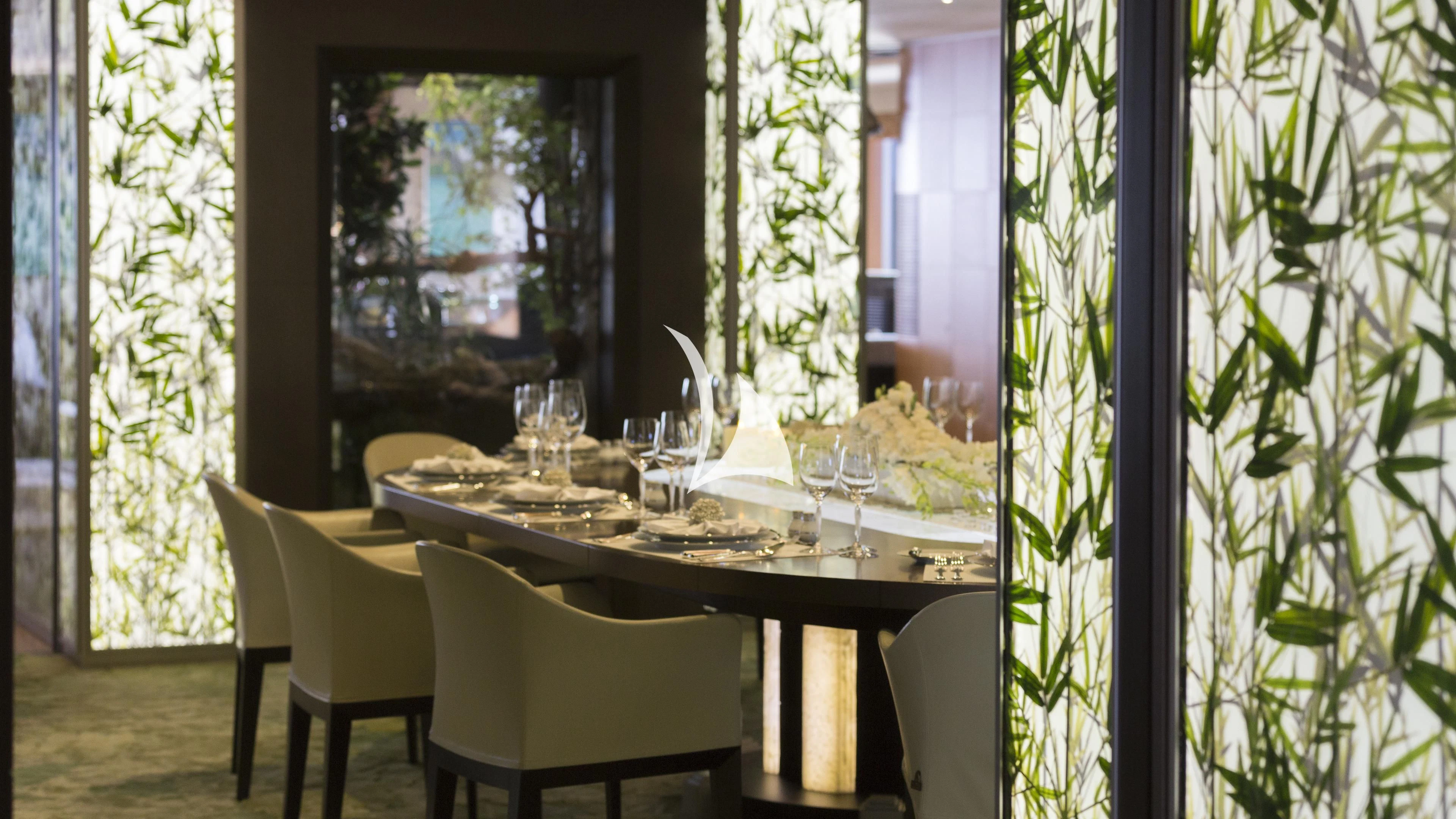 a table with wine glasses on it aboard NIRVANA Yacht for Sale