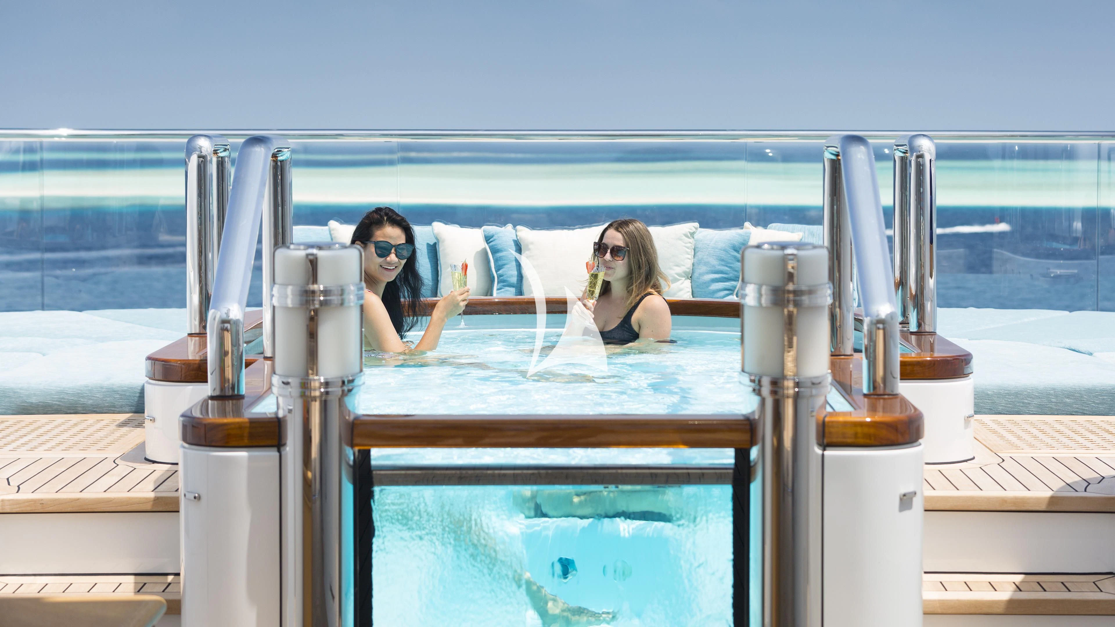 a couple of women sitting at a table in a boat aboard NIRVANA Yacht for Sale