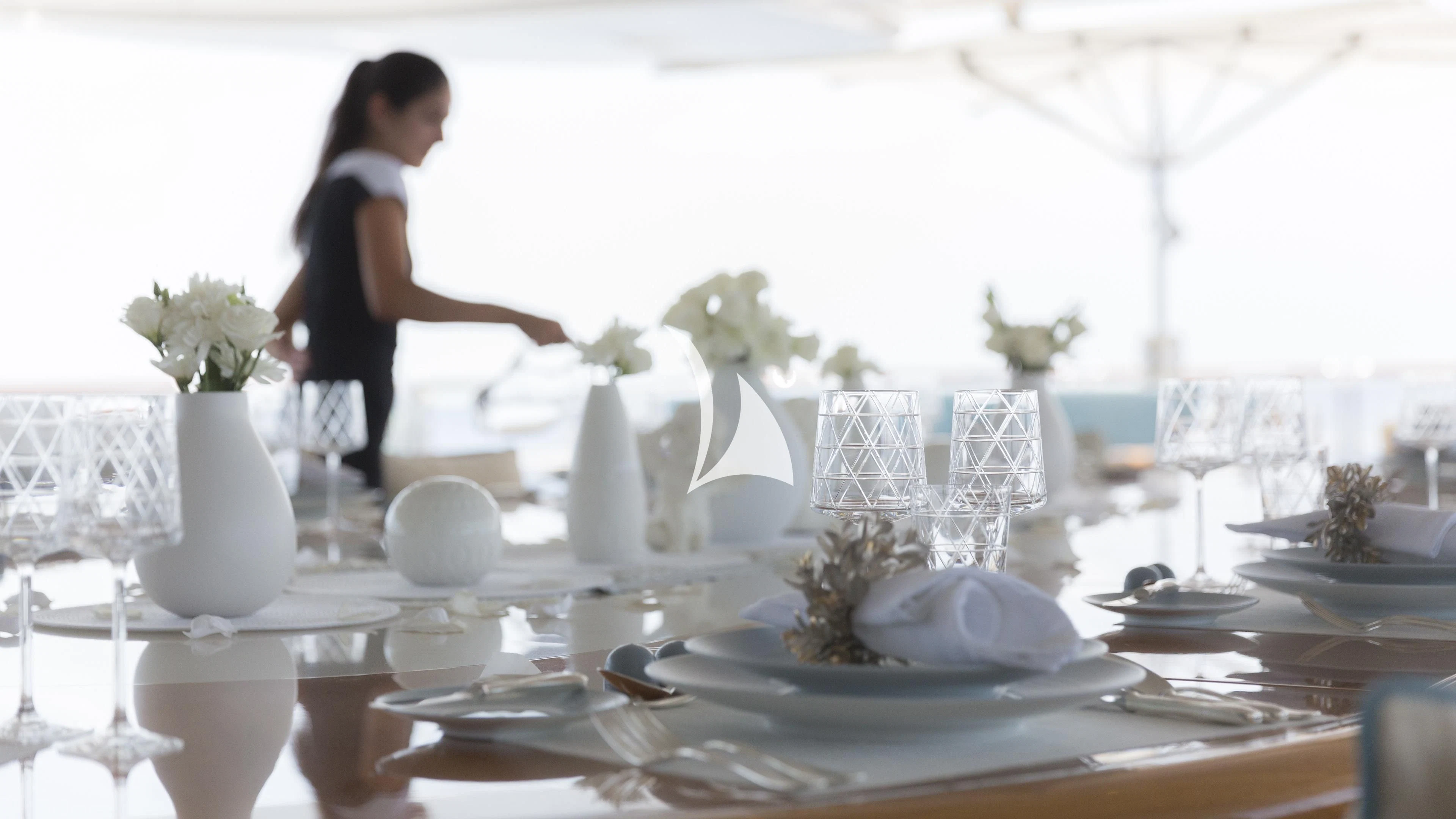 a person sitting at a table aboard NIRVANA Yacht for Sale