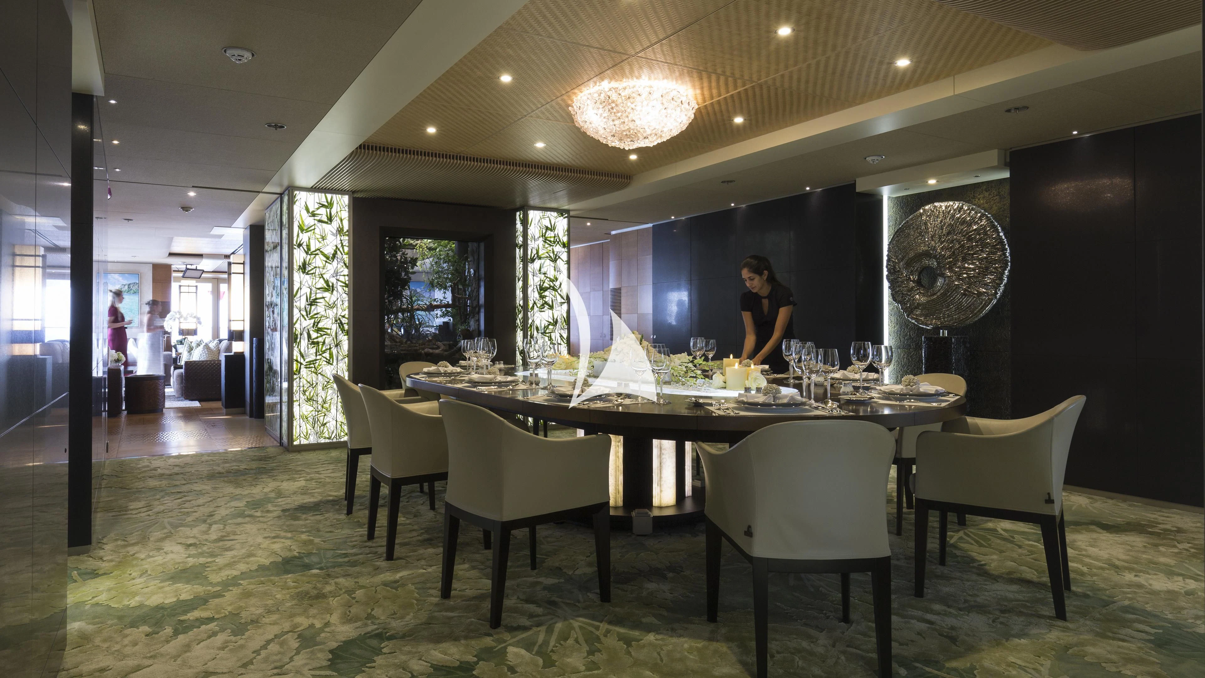 a person standing at a table aboard NIRVANA Yacht for Sale