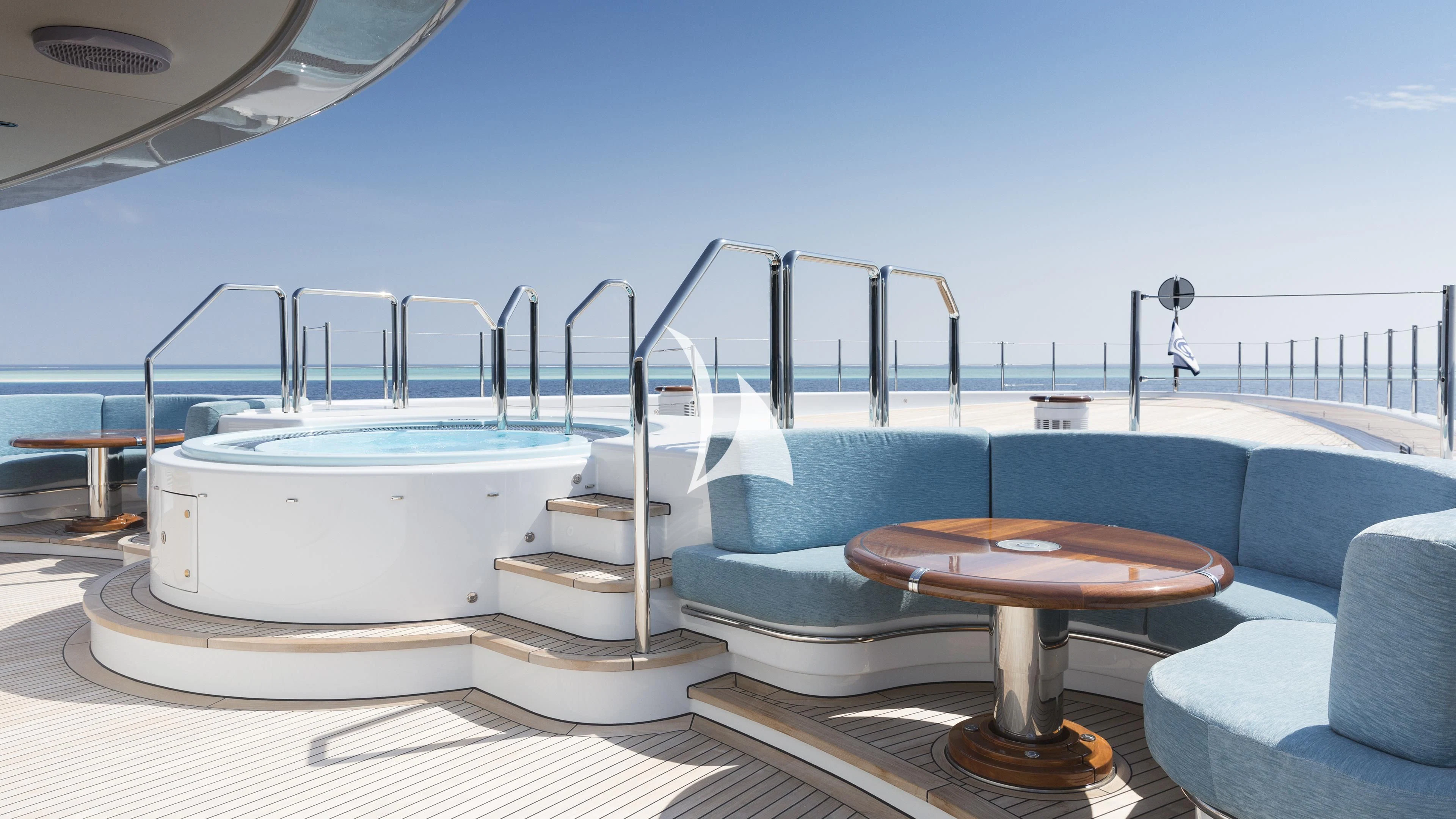 a pool with a table and chairs aboard NIRVANA Yacht for Sale