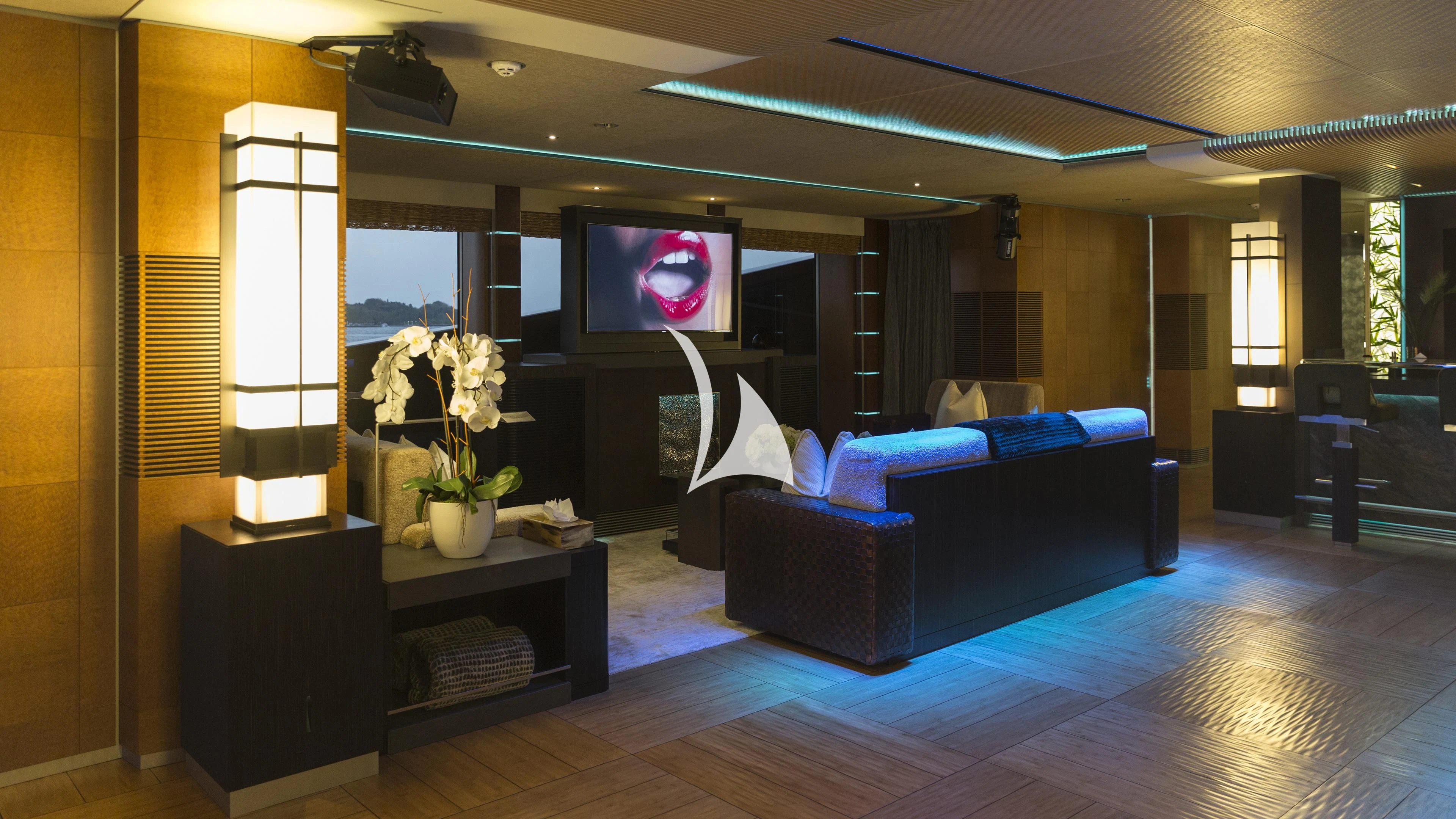 a living room with a large screen aboard NIRVANA Yacht for Sale