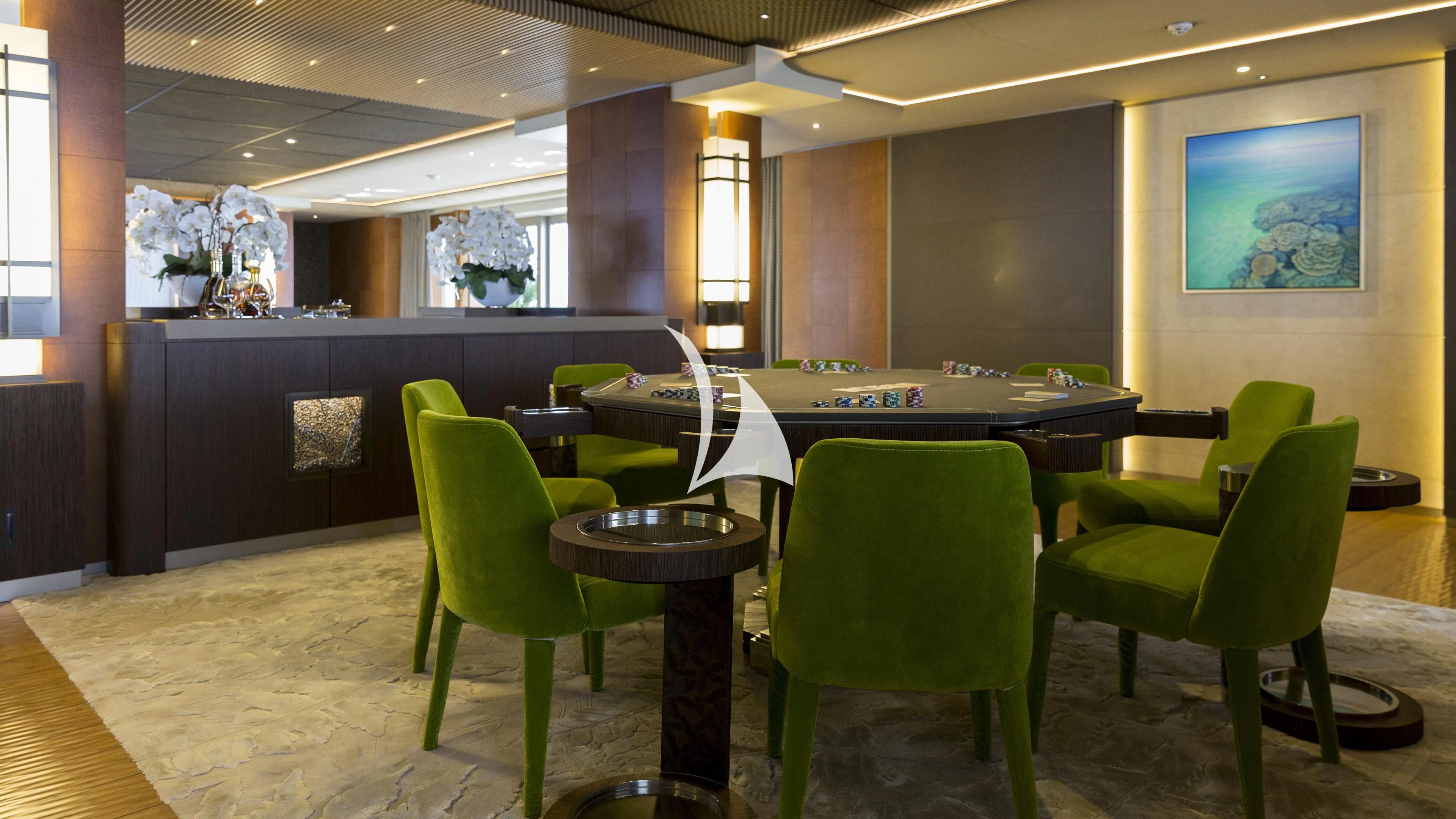 a room with green chairs and tables aboard NIRVANA Yacht for Sale