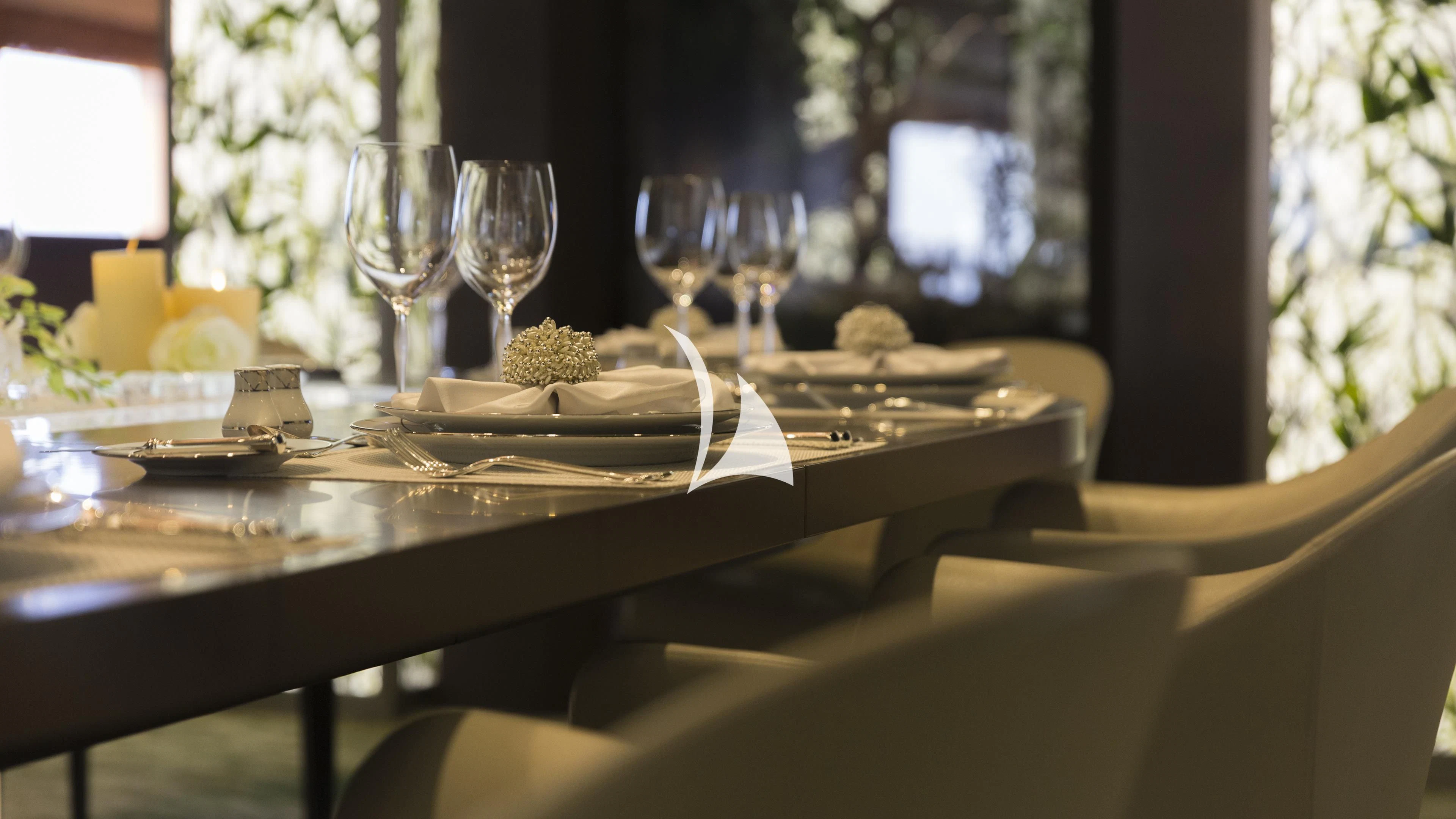 a table set with plates and glasses aboard NIRVANA Yacht for Sale
