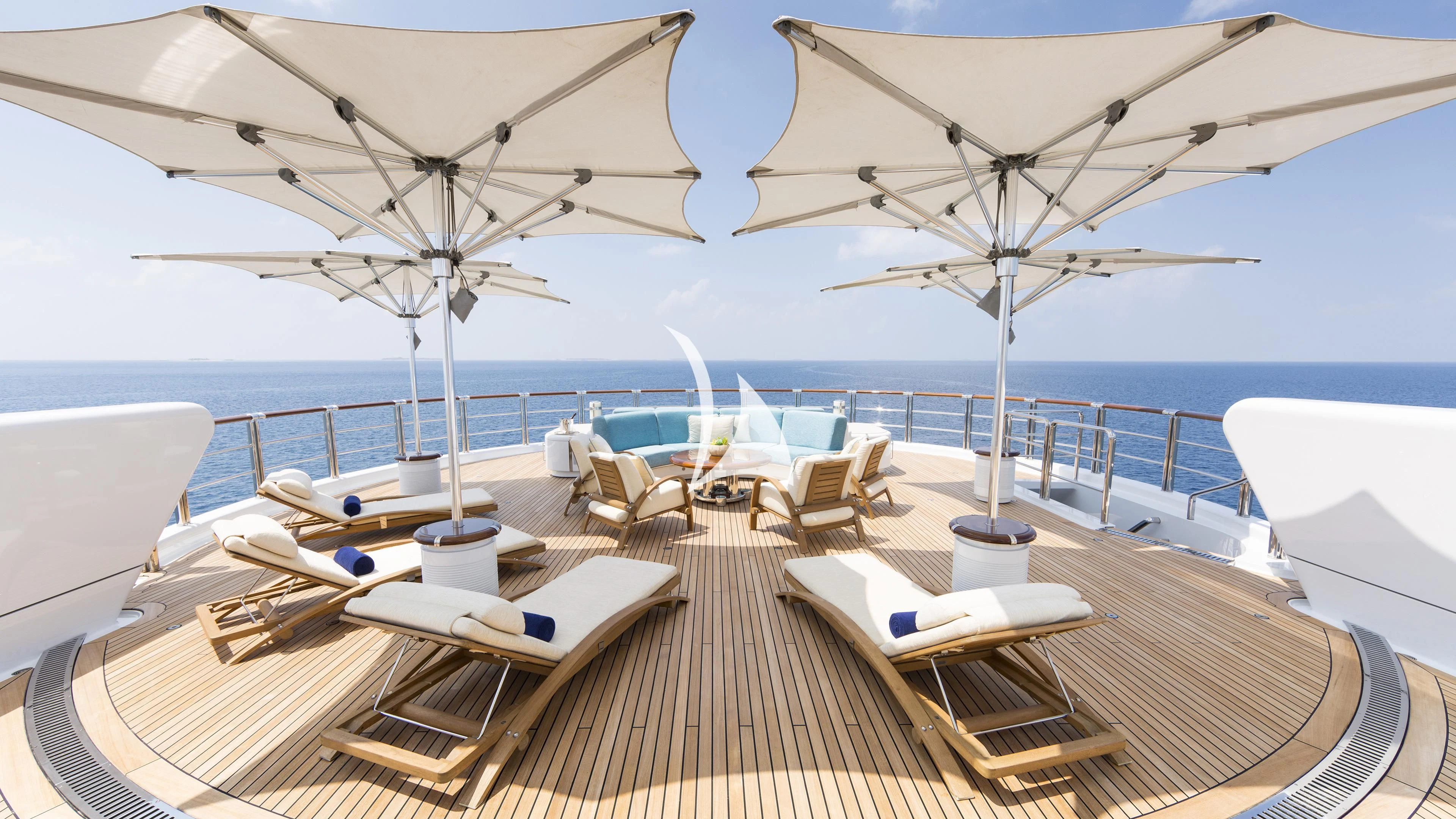 a deck with lounge chairs and umbrellas on it aboard NIRVANA Yacht for Sale