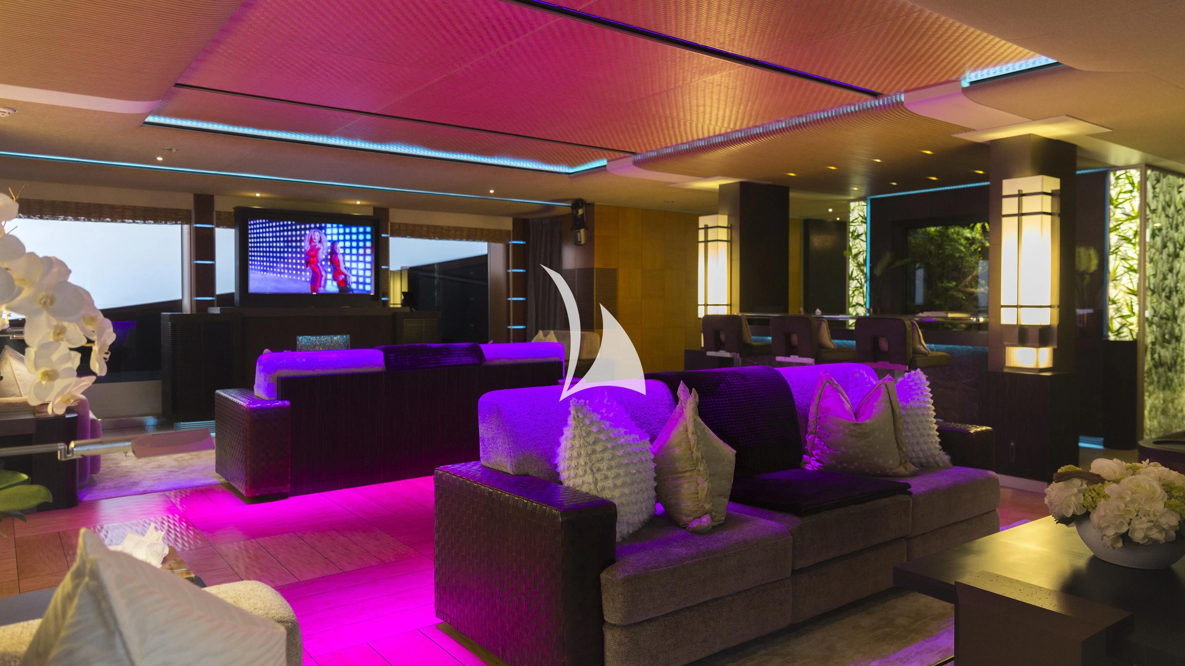 a living room with purple and purple furniture aboard NIRVANA Yacht for Sale