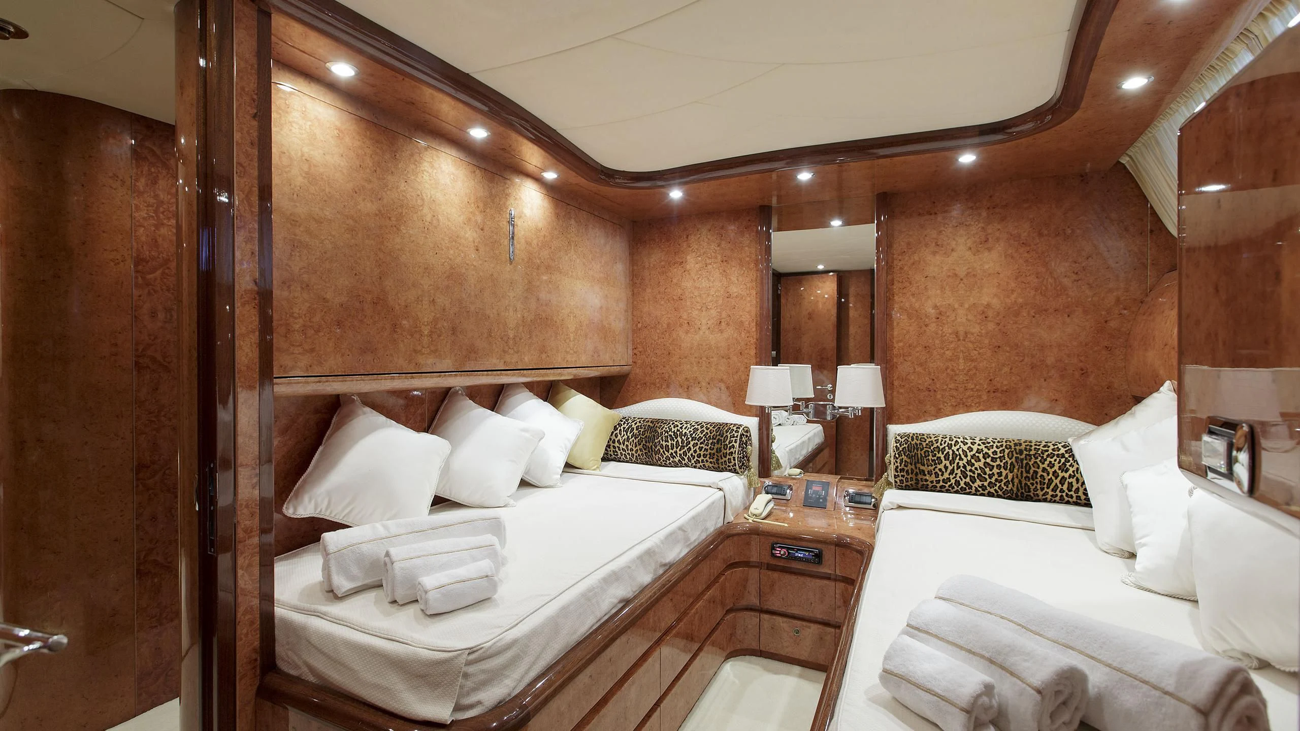 a room with beds and a mirror aboard SEA JAGUAR Yacht for Sale