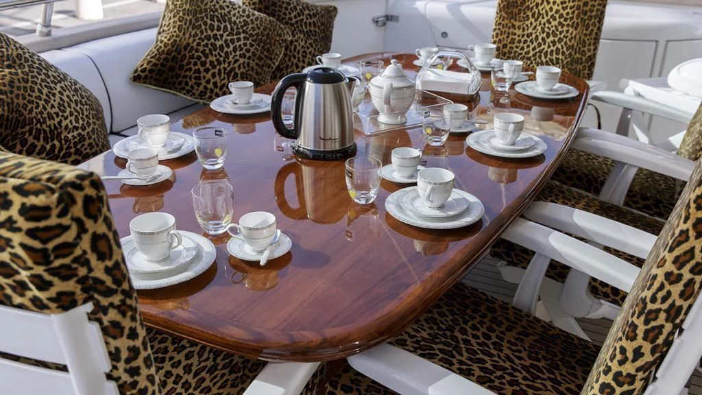 a table with tea cups and saucers on it aboard SEA JAGUAR Yacht for Sale