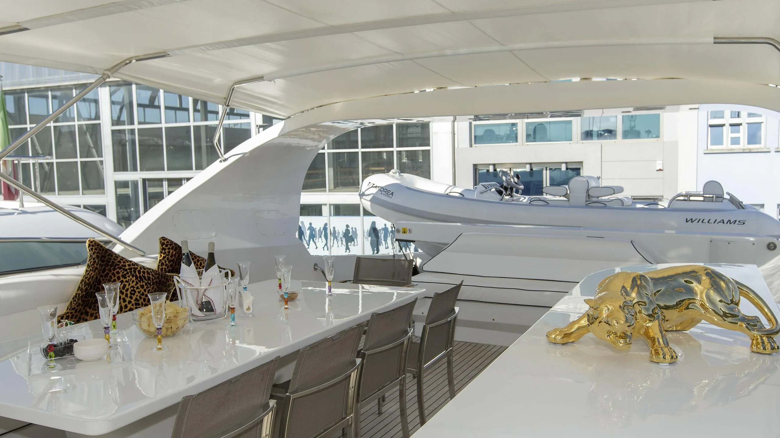 a large goldfish on a table in a room with chairs and a table with a glass window aboard SEA JAGUAR Yacht for Sale