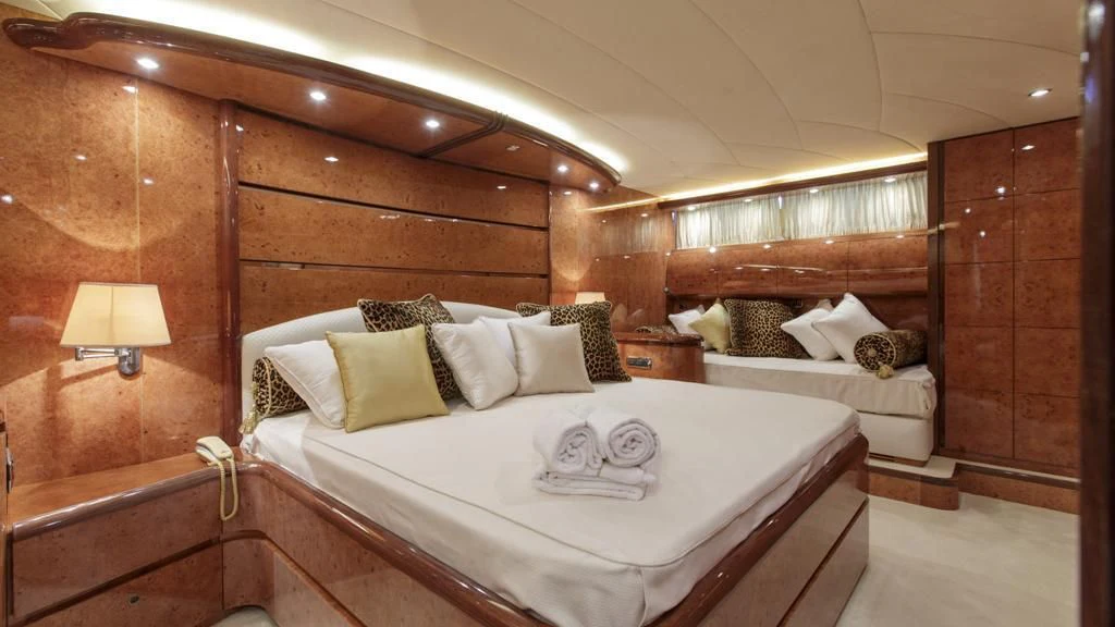 a room with a bed and a lamp aboard SEA JAGUAR Yacht for Sale