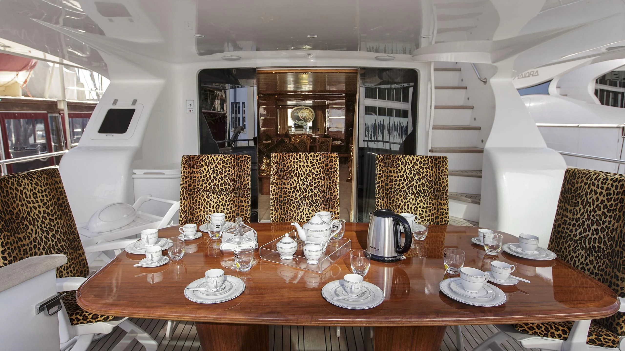 a table with plates and cups on it aboard SEA JAGUAR Yacht for Sale