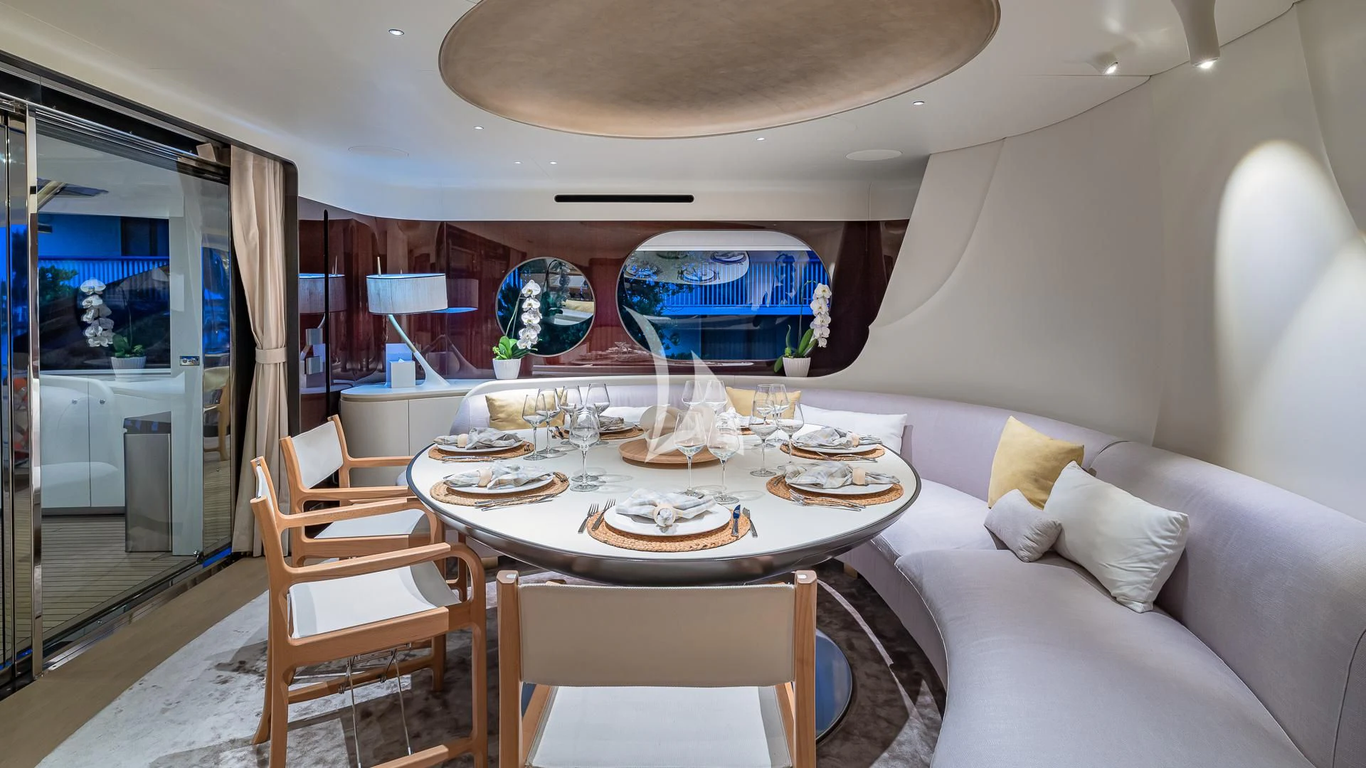 a dining room with a large round table and chairs aboard VOLO MARE Yacht for Charter