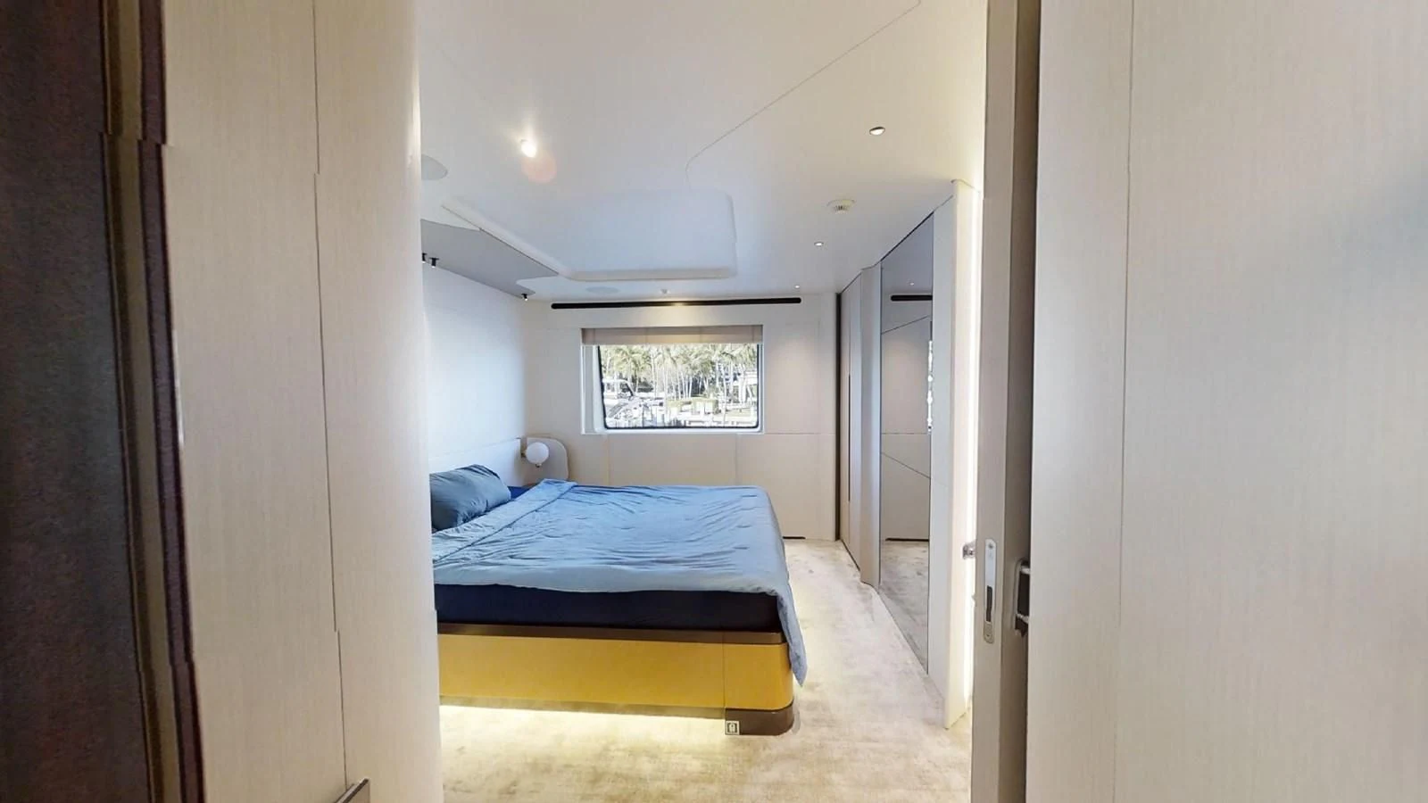 a bedroom with a blue bed aboard VOLO MARE Yacht for Charter