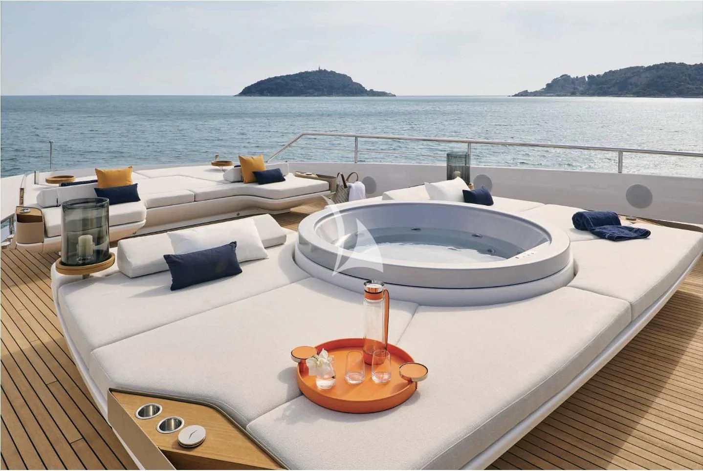 a white bathtub with a sink and a large body of water in the background aboard VOLO MARE Yacht for Charter