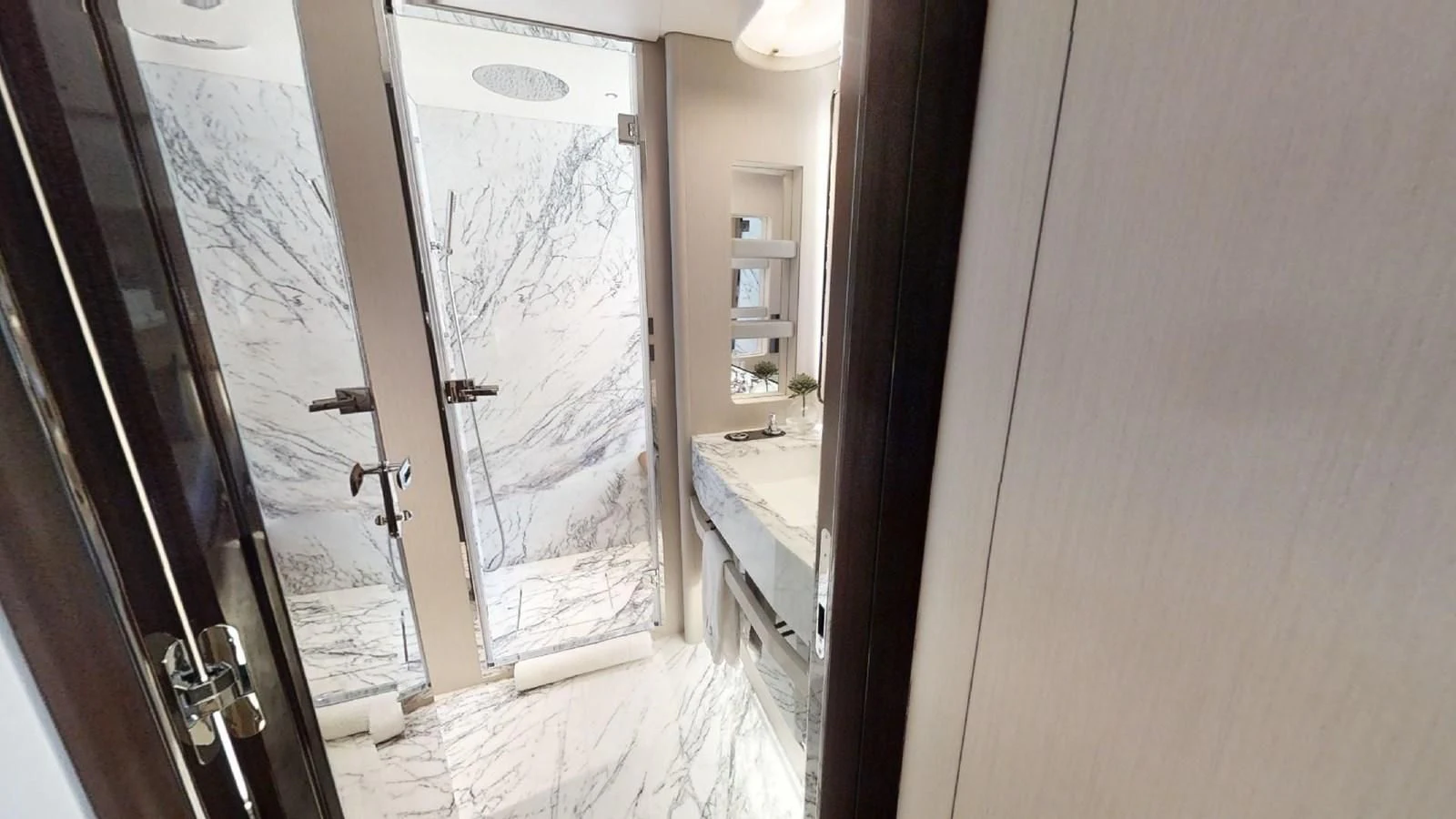 a room with a glass door and a window with a sink and a mirror aboard VOLO MARE Yacht for Charter