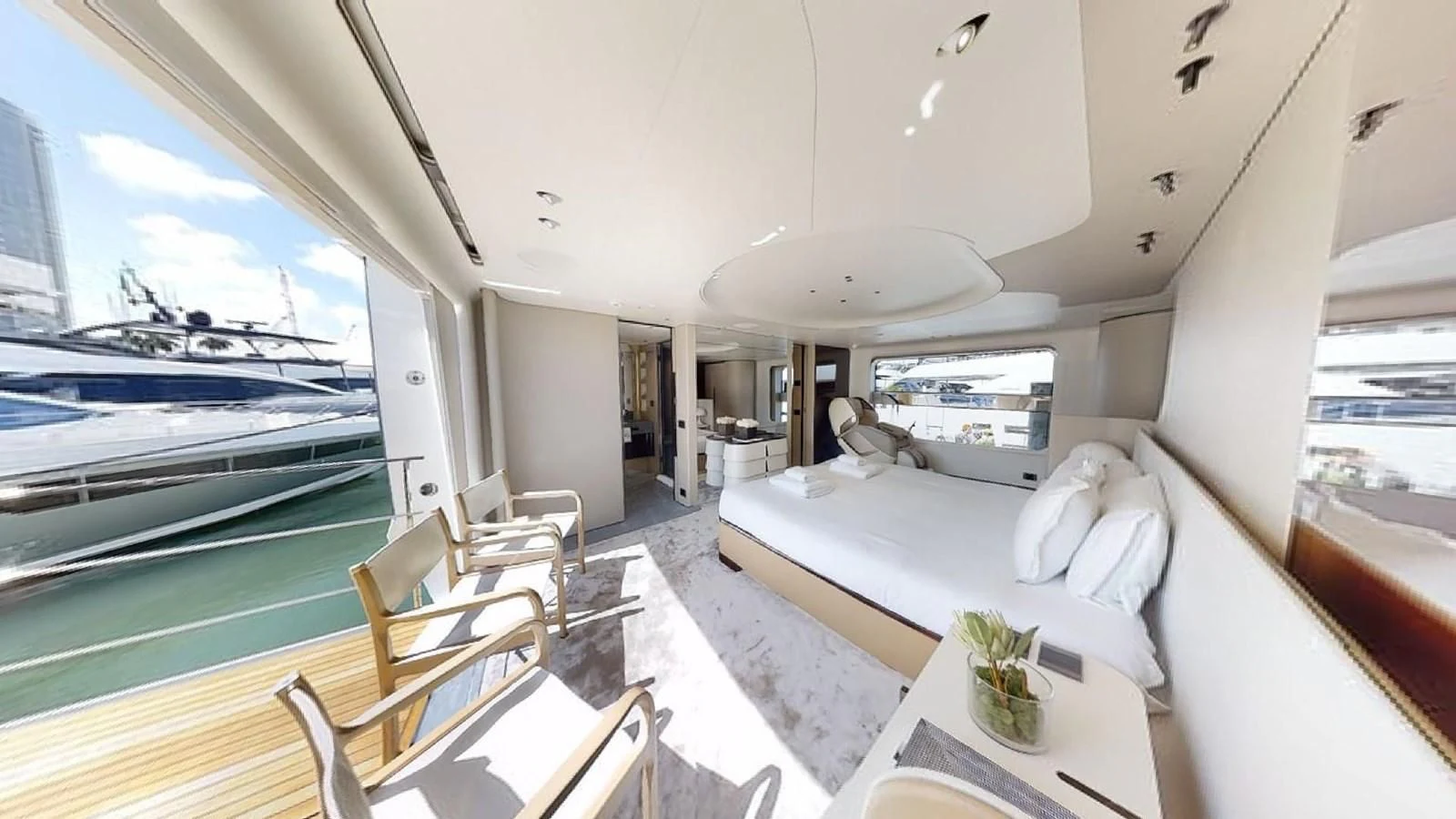 a room with a bed and a table and chairs aboard VOLO MARE Yacht for Charter