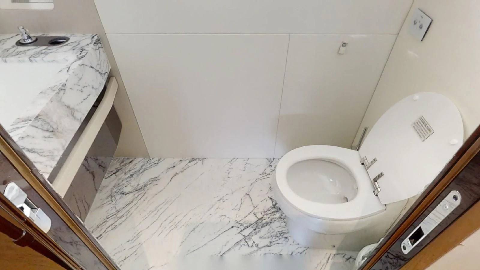 a bathroom with a toilet and a sink aboard VOLO MARE Yacht for Charter