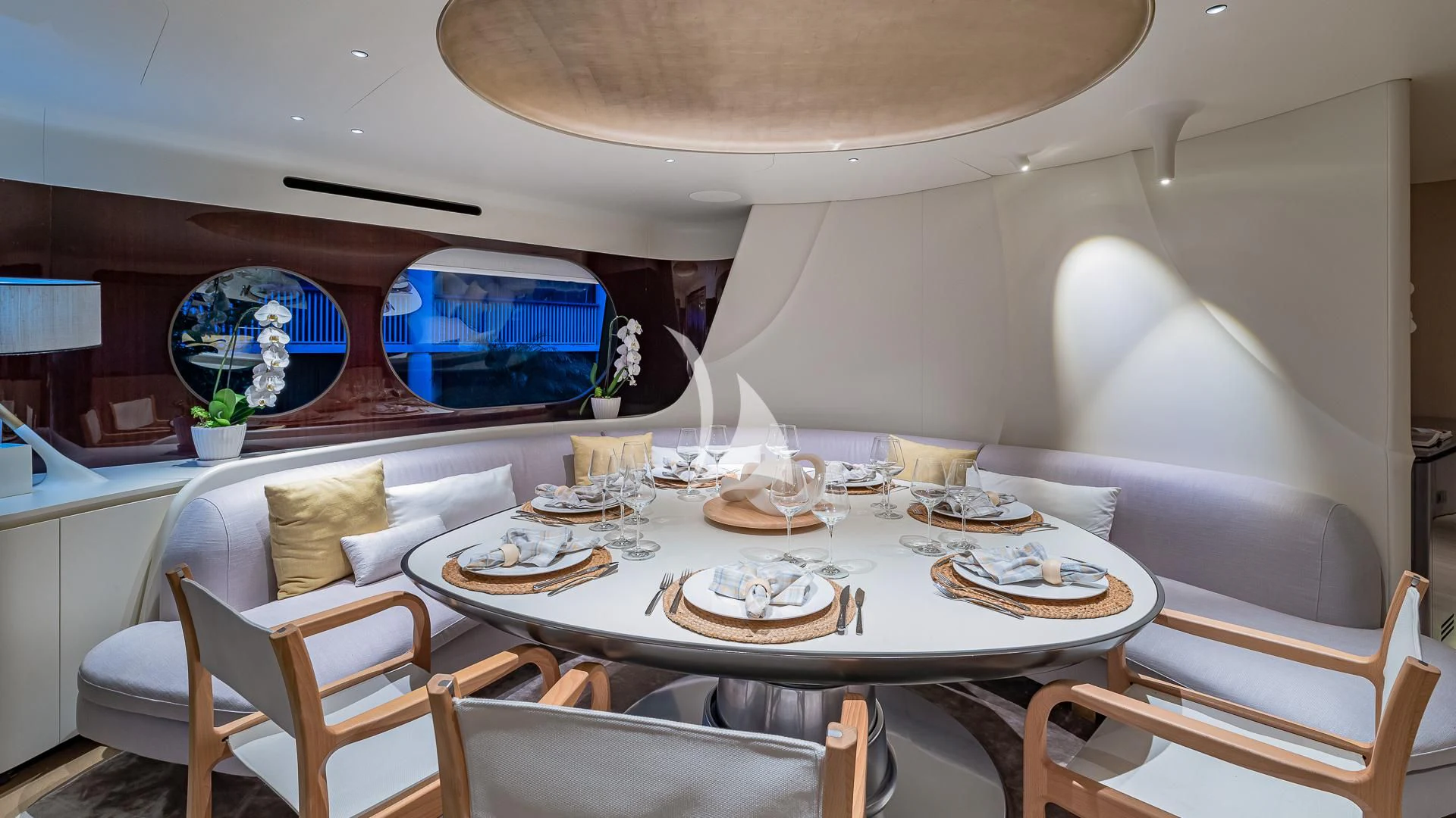 a dining table with plates and glasses aboard VOLO MARE Yacht for Charter