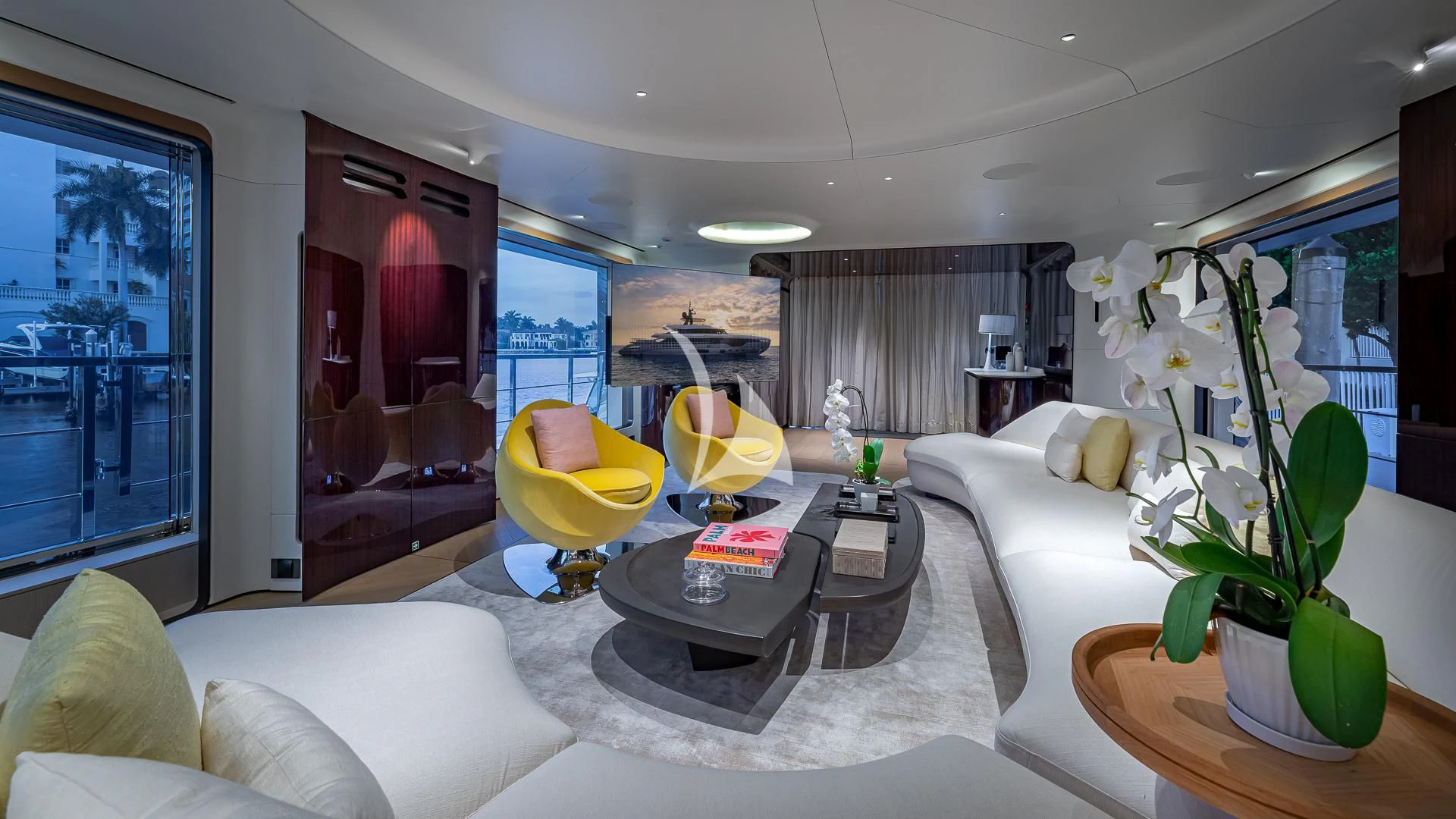 a living room with a large white couch and a table aboard VOLO MARE Yacht for Charter