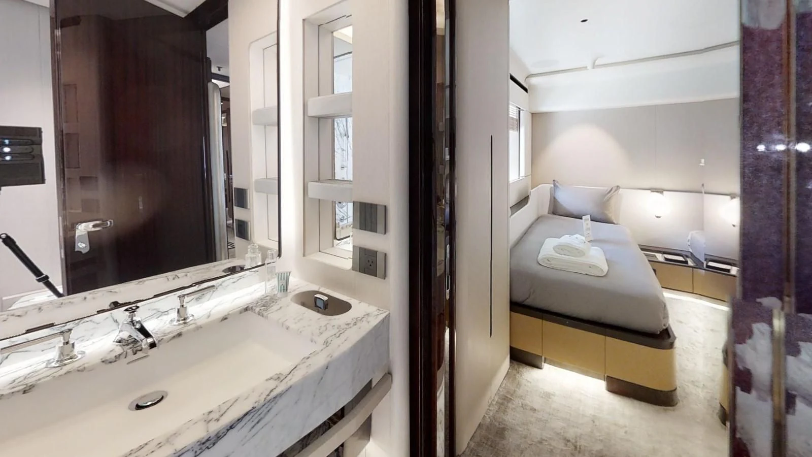 a bathroom with a sink and a bed aboard VOLO MARE Yacht for Charter