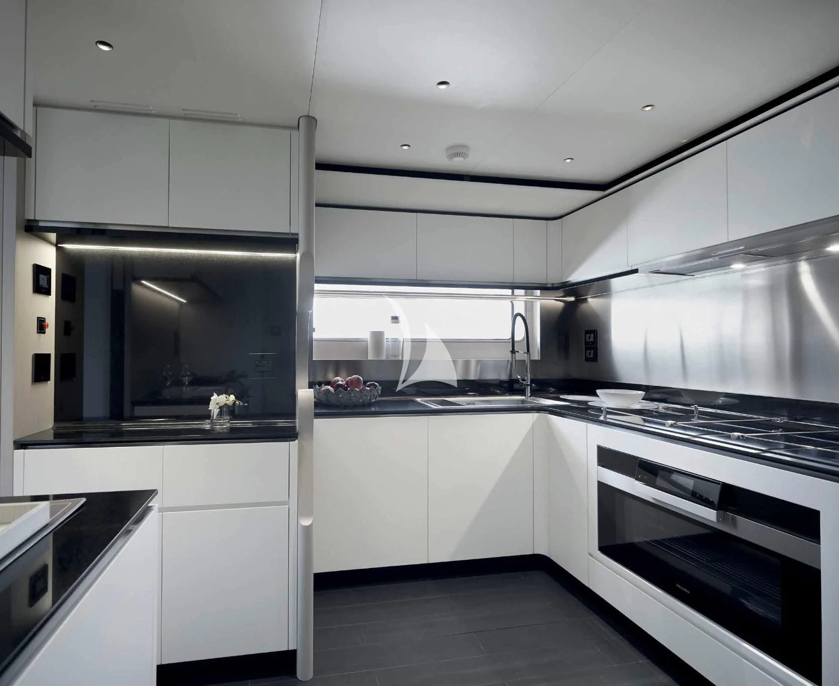 a kitchen with white cabinets aboard VOLO MARE Yacht for Charter