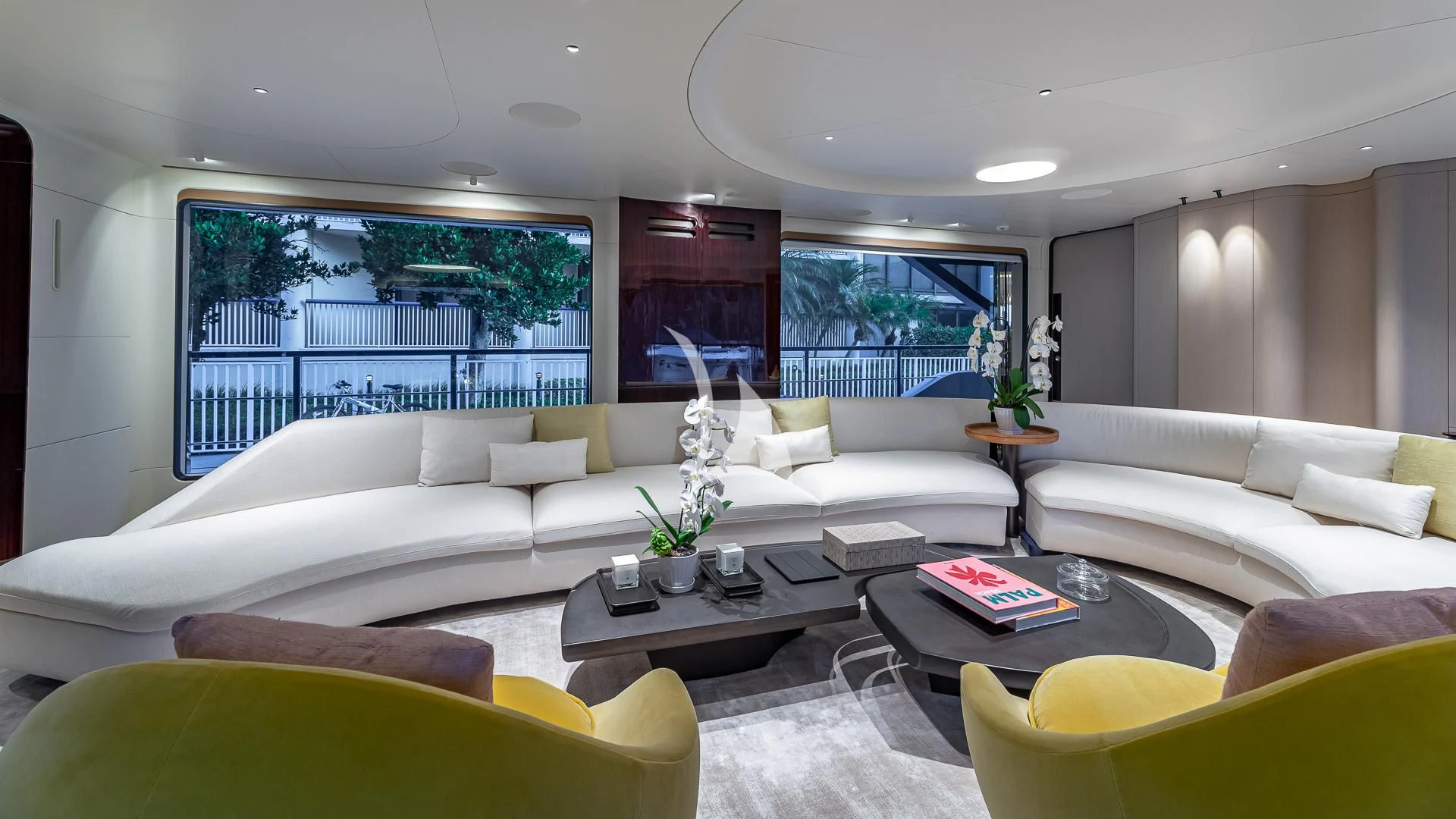 a living room with white couches aboard VOLO MARE Yacht for Charter