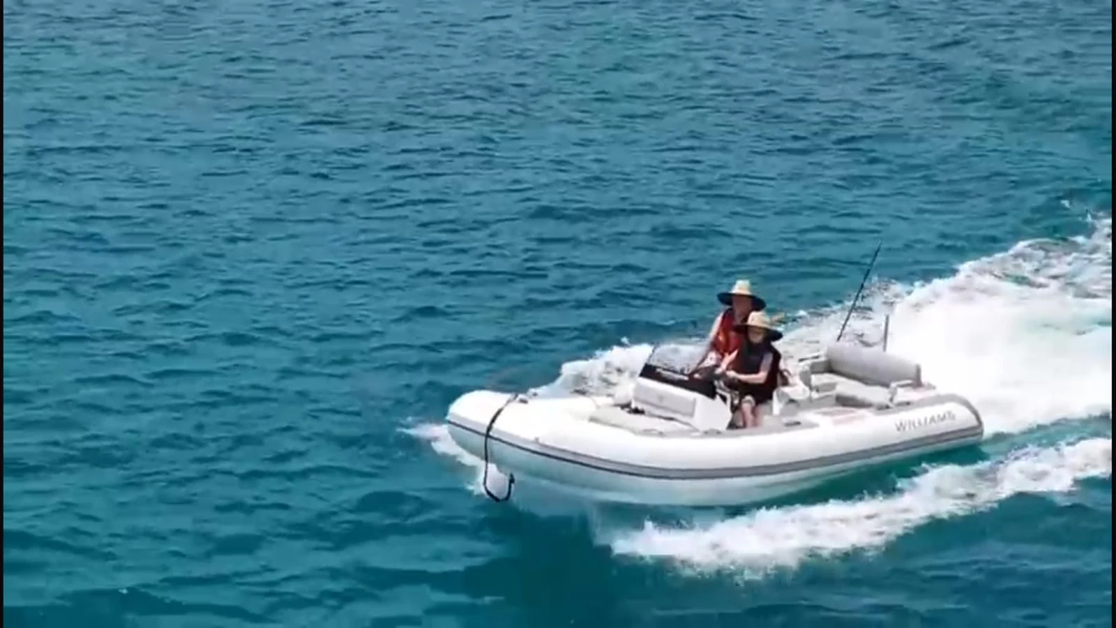 a man and a woman in a speedboat on the water aboard VOLO MARE Yacht for Charter