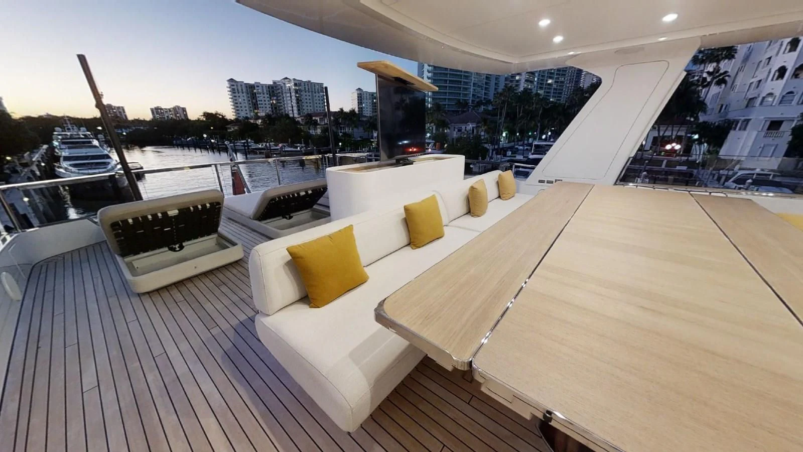 a deck with a couch and a table on it aboard VOLO MARE Yacht for Charter