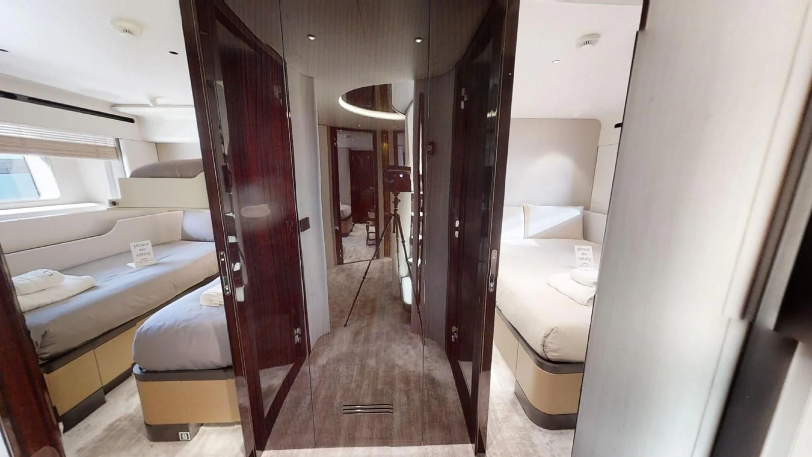 a room with beds and a closet aboard VOLO MARE Yacht for Charter