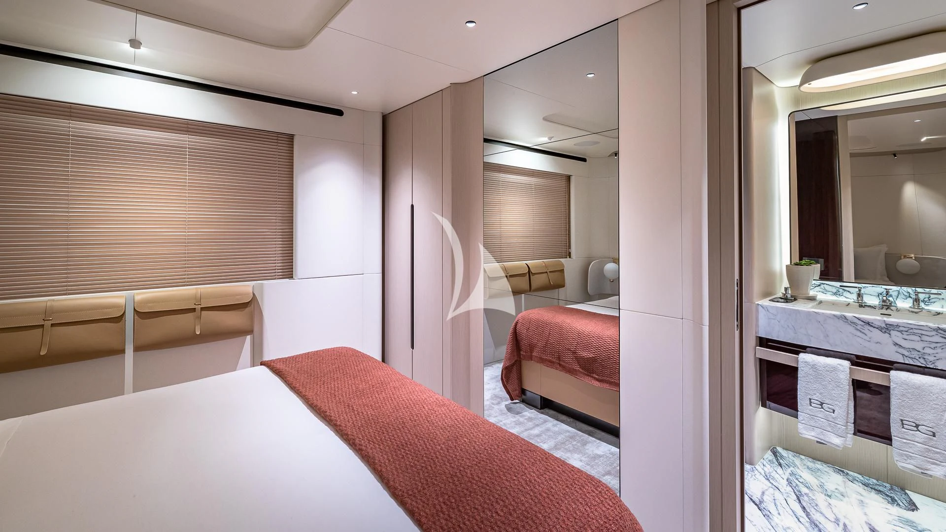 a room with a bed and a mirror aboard VOLO MARE Yacht for Charter